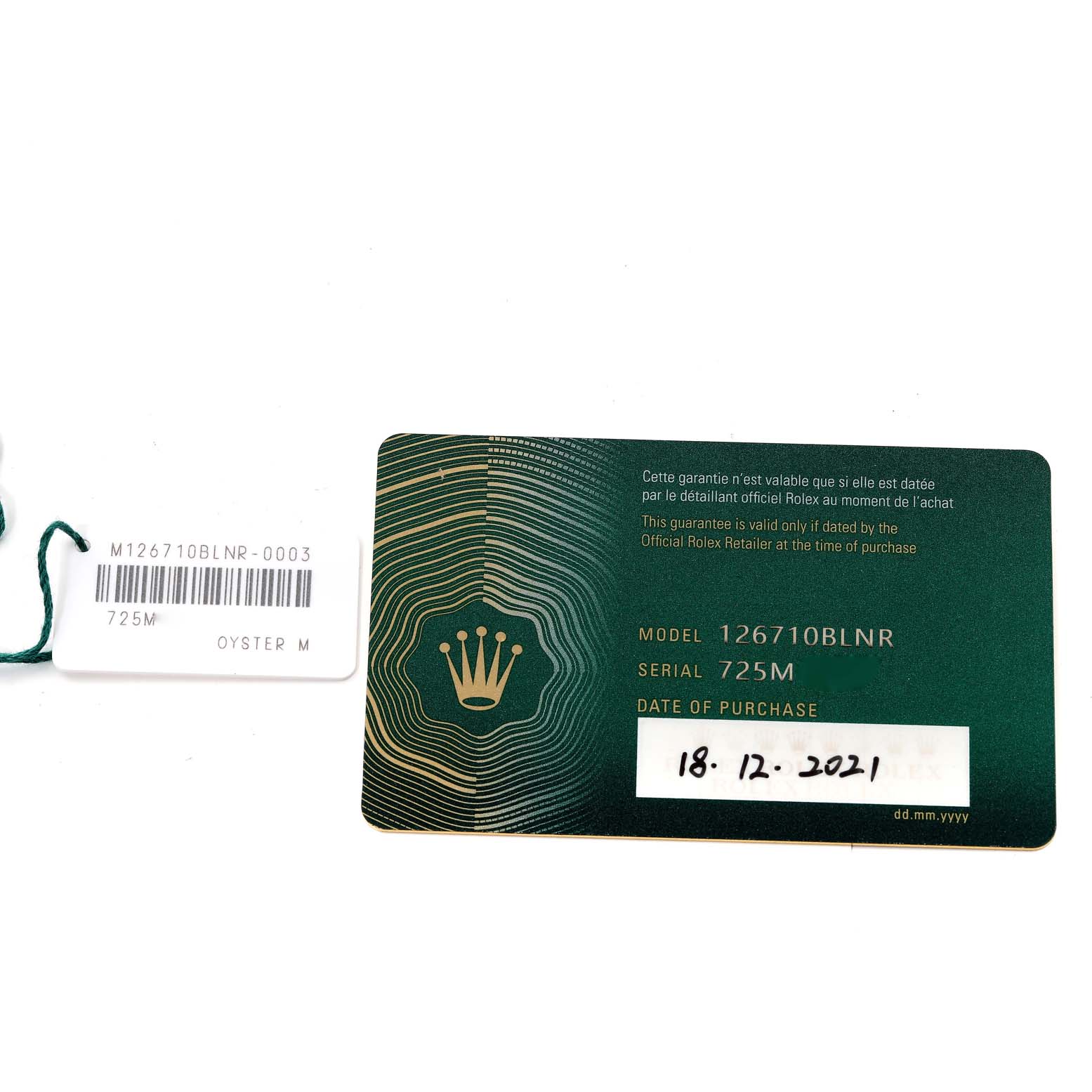 The image shows a warranty card and a tag for a Rolex GMT-Master 126710 Men's Stainless Steel Black Dial 126710 Men's Stainless Steel Black Dial model 126710BLNR watch.
