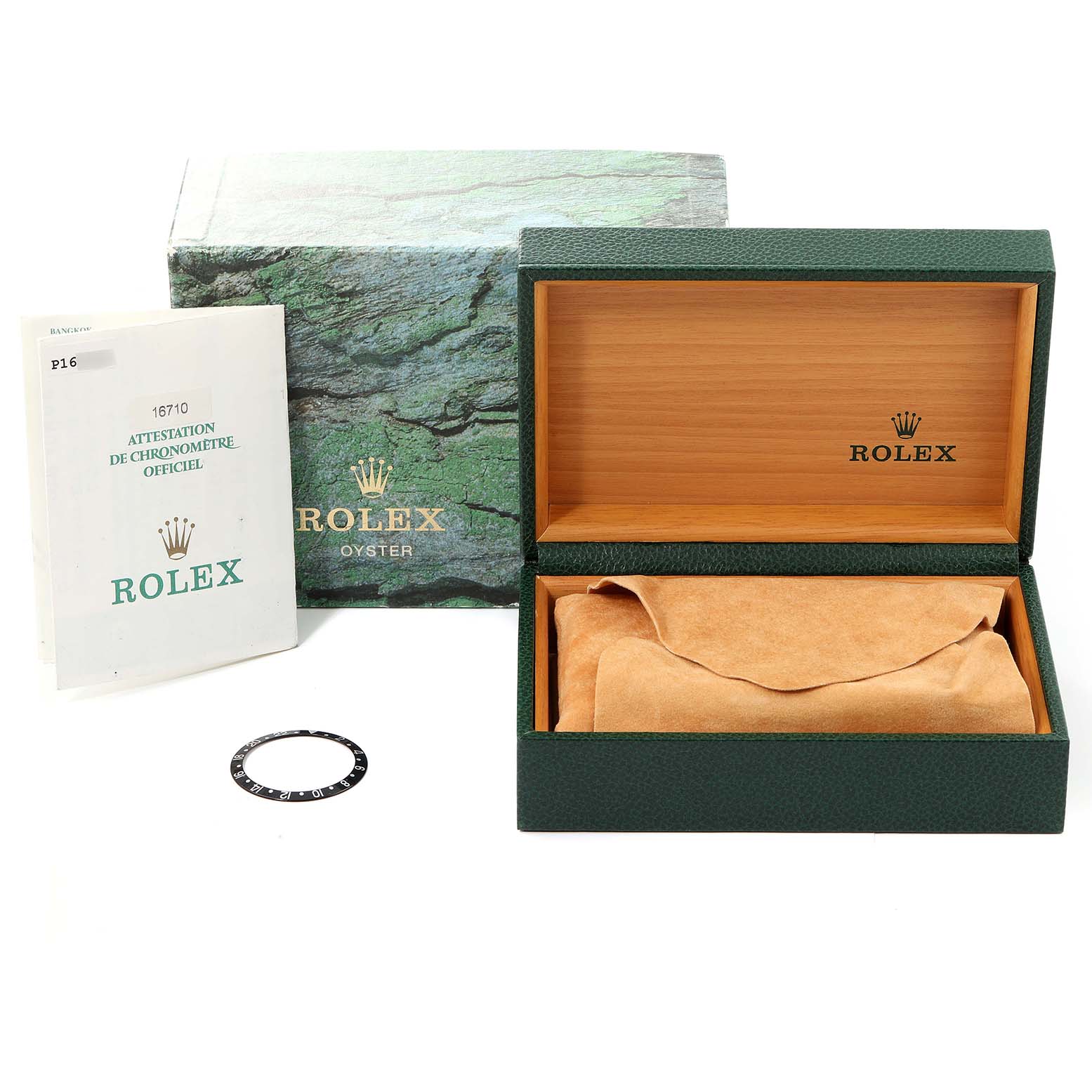 The image shows a Rolex GMT-Master 16710 Men
s Stainless Steel Black Dial 16710 Men
s Stainless Steel Black Dial watch box, an official certificate, and a bezel ring from a top-down angle.