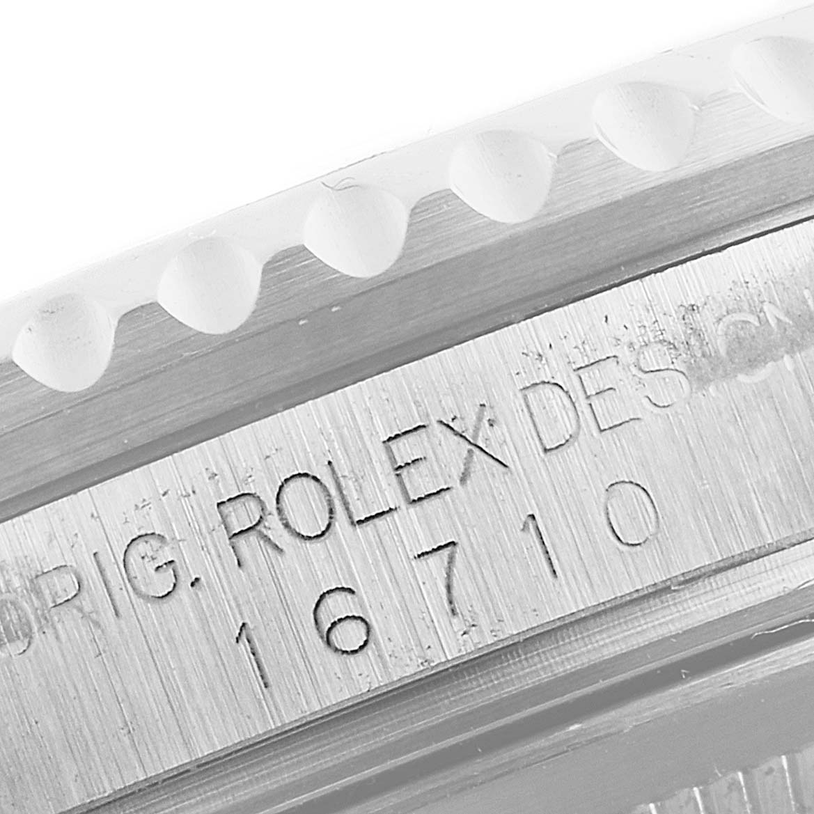 Close-up of the Rolex GMT-Master 16710 Men
s Stainless Steel Black Dial 16710 Men
s Stainless Steel Black Dial
s case showing the model number 16710 engraved on it.