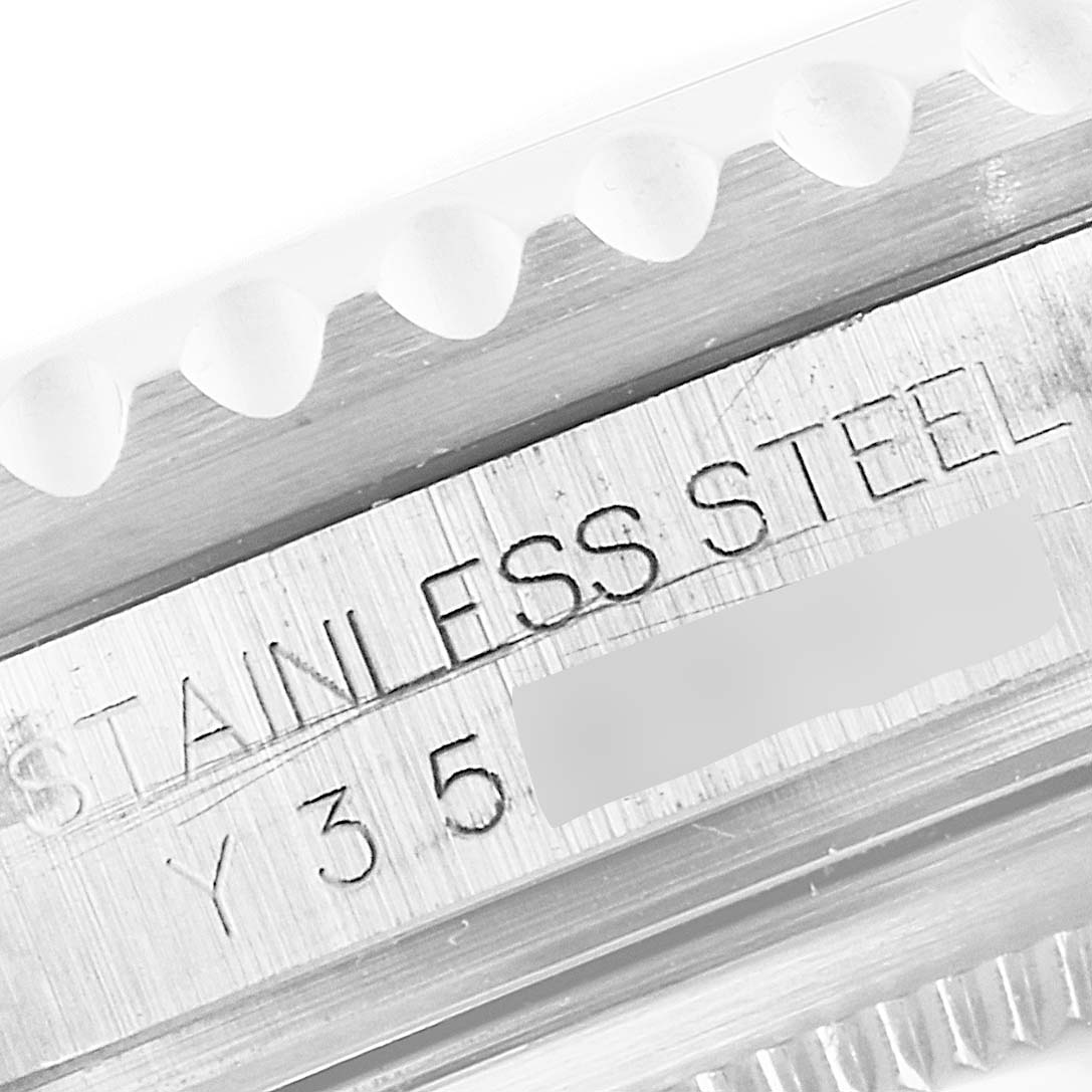 The image shows a close-up of the side of a Rolex GMT-Master 16710 Men
s Stainless Steel Black Dial 16710 Men
s Stainless Steel Black Dial watch case, displaying the "STAINLESS STEEL" engraving.