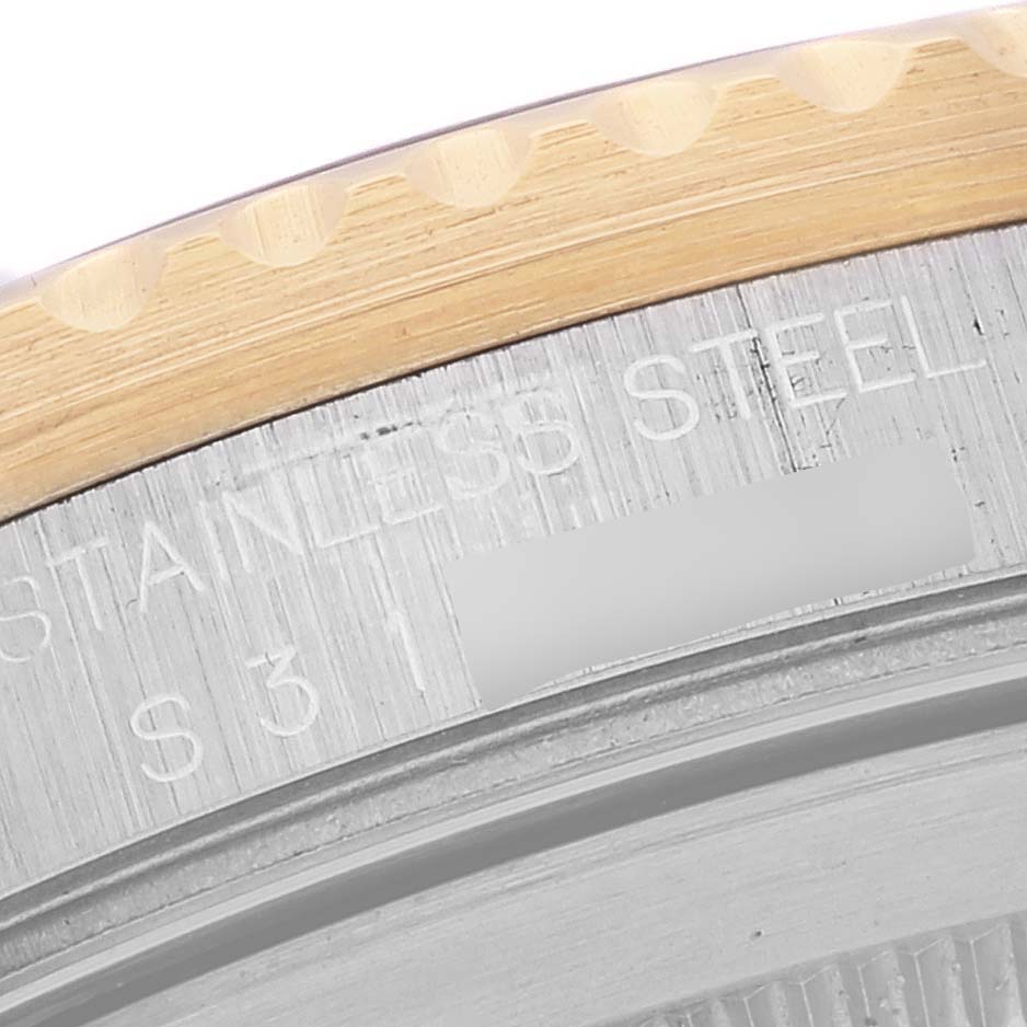 This image shows a close-up of the edge and case back of a Rolex GMT-Master 16713 Men's Stainless Steel Brown Dial 16713 Men's Stainless Steel Brown Dial watch, focusing on the stainless steel and gold bezel.