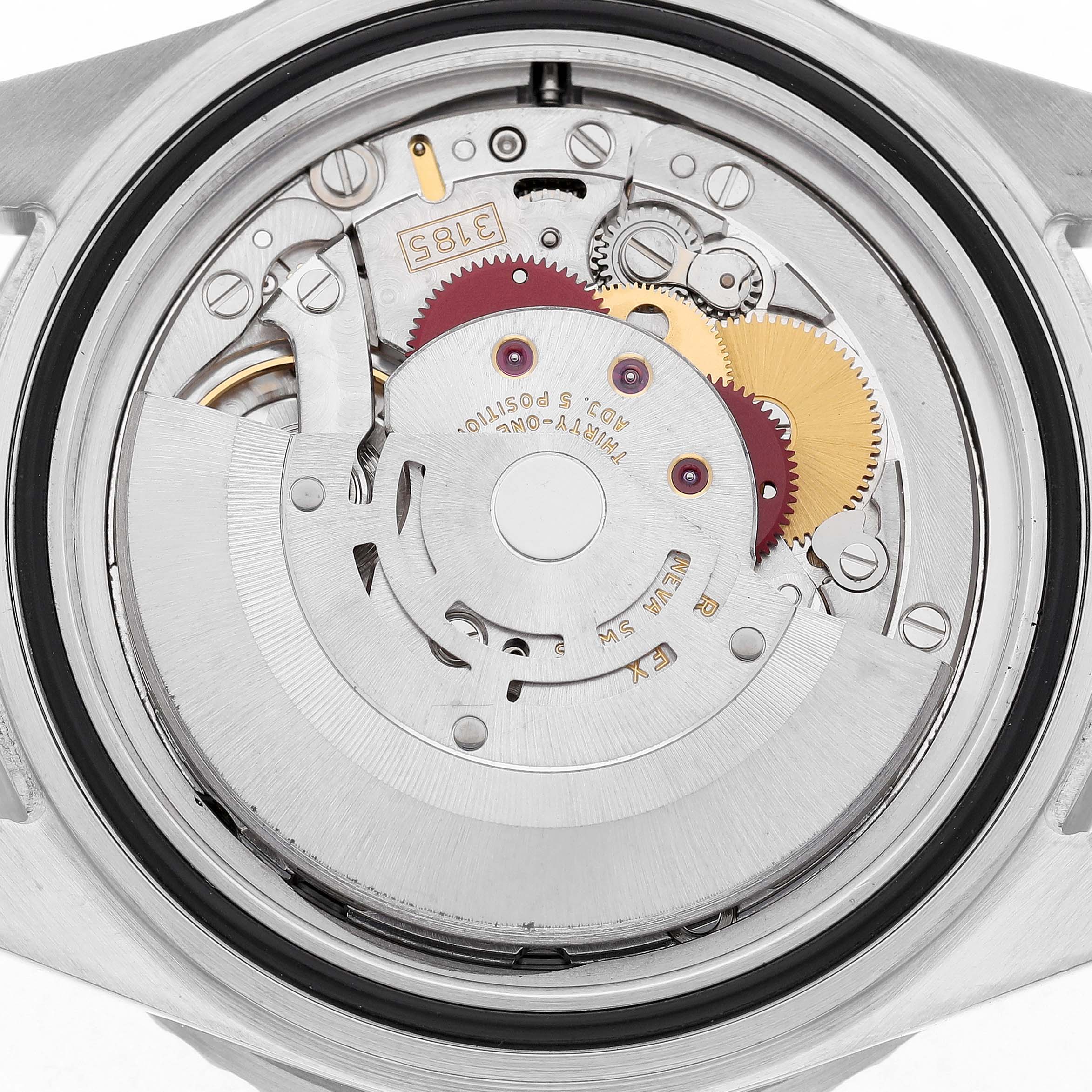 The image shows the movement of a Rolex GMT-Master 16710 T Men's Stainless Steel Black Dial watch from a top-down perspective, highlighting gears and the rotor.
