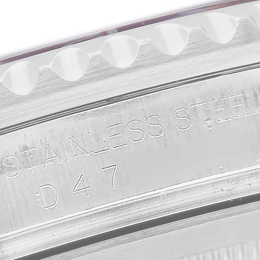 The image shows a close-up of the side profile of the Rolex GMT-Master 16710 T Men's Stainless Steel Black Dial, focusing on the stainless steel engraving.