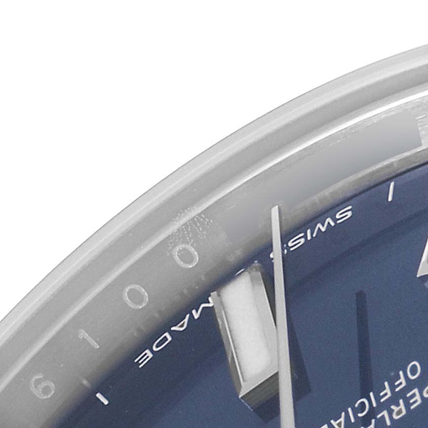 The image shows a close-up of the dial on a Rolex Mid-Size 277200 Women's Stainless Steel Blue Dial 277200 Women's Stainless Steel Blue Dial model, capturing the edge of the dial and the minute hand.