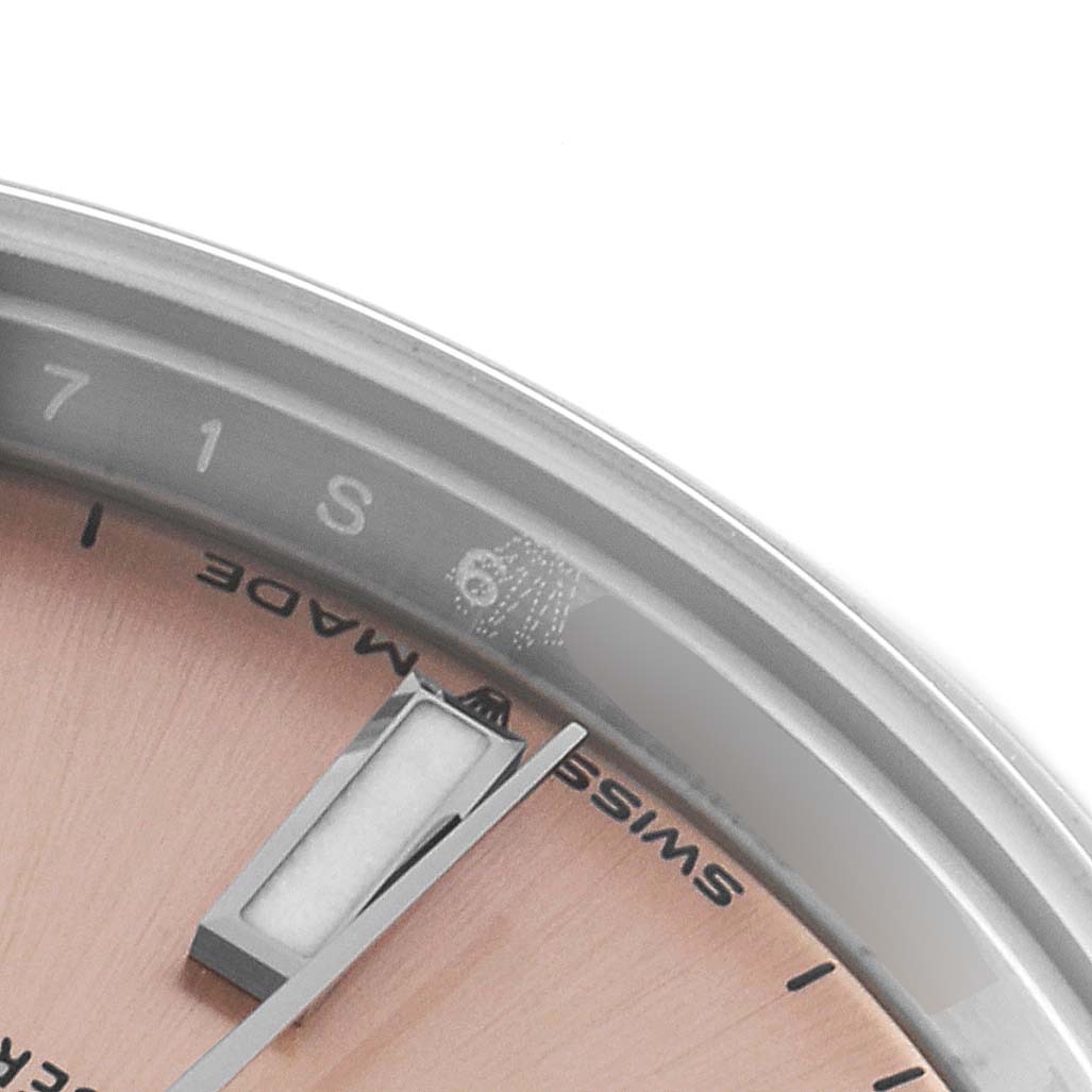 The image shows a close-up of the dial and edge of the bezel of a mid-size Rolex watch.