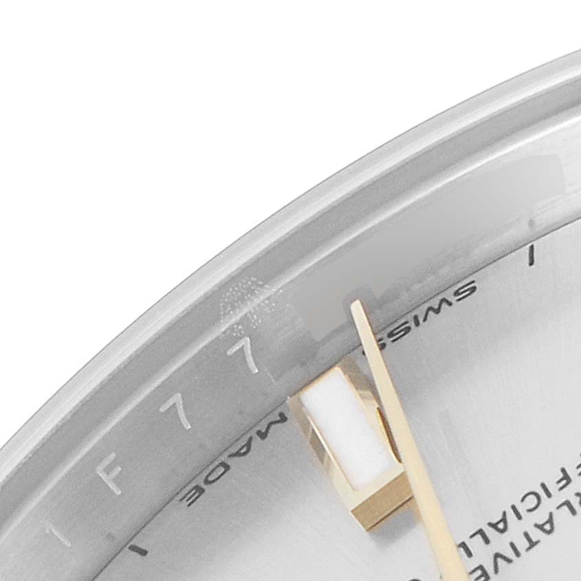 The image shows a close-up view of the dial and partial second hand of a Mid-Size Rolex watch.