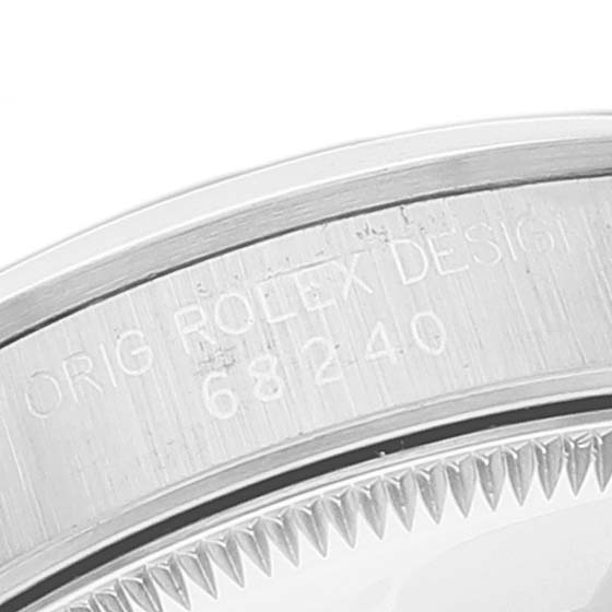 The image shows a close-up of the case back with engraving details of the Rolex Mid-Size 68240 Women
s Stainless Steel Blue Dial 68240 Women
s Stainless Steel Blue Dial model.
