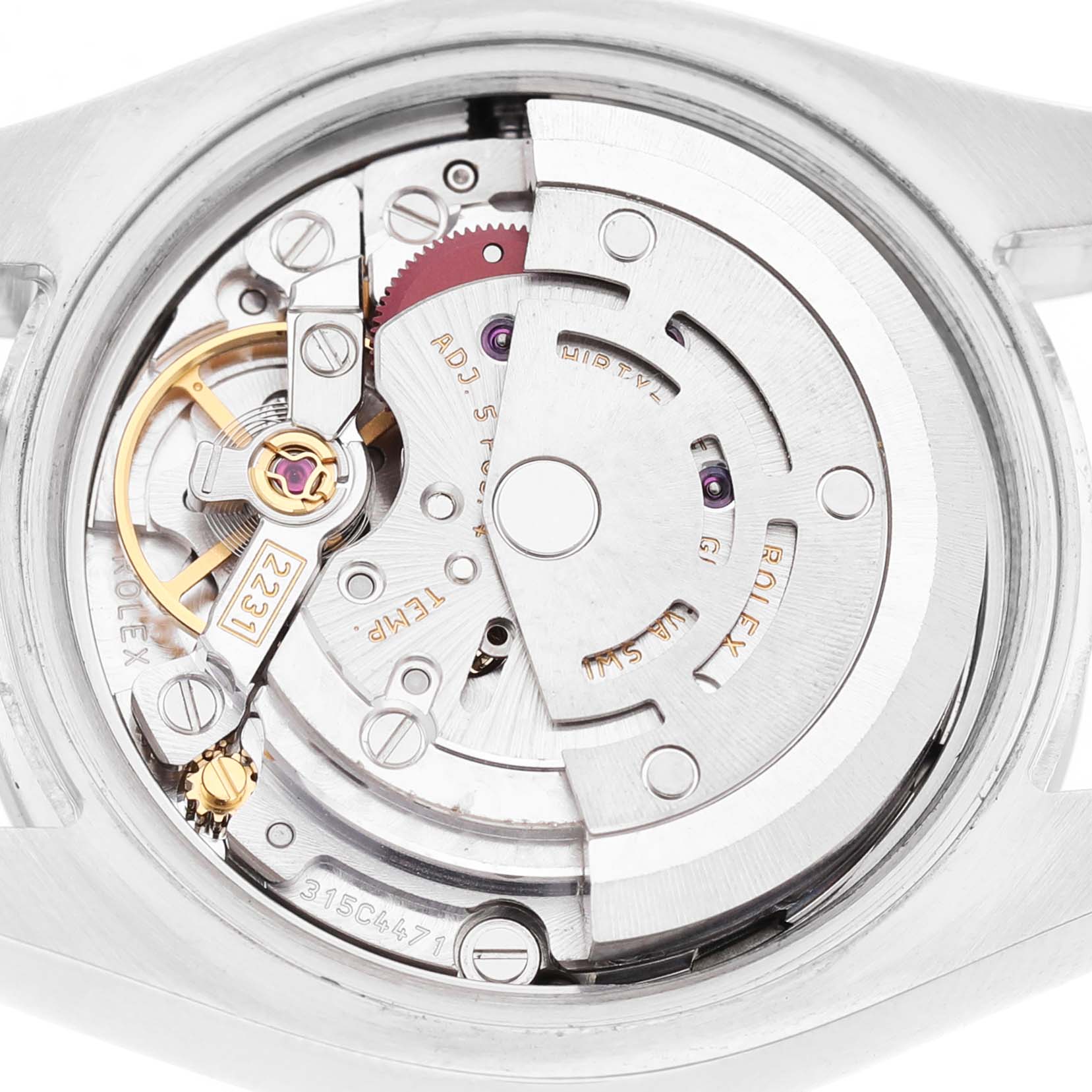 The image shows the movement mechanism of a Rolex Oyster Perpetual 176200 Women's Stainless Steel Silver Dial watch from a back angle, highlighting gears and the rotor.