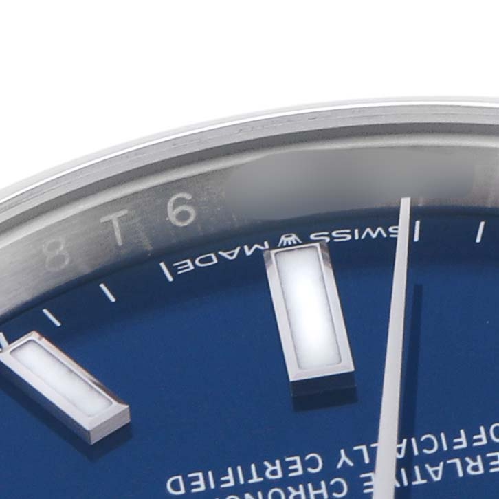 The image shows a close-up of the Rolex Oyster Perpetual 124200 Men
s Stainless Steel Blue Dial 124200 Men
s Stainless Steel Blue Dial watch face, highlighting the hour markers, minute hand, and the edge of the dial.