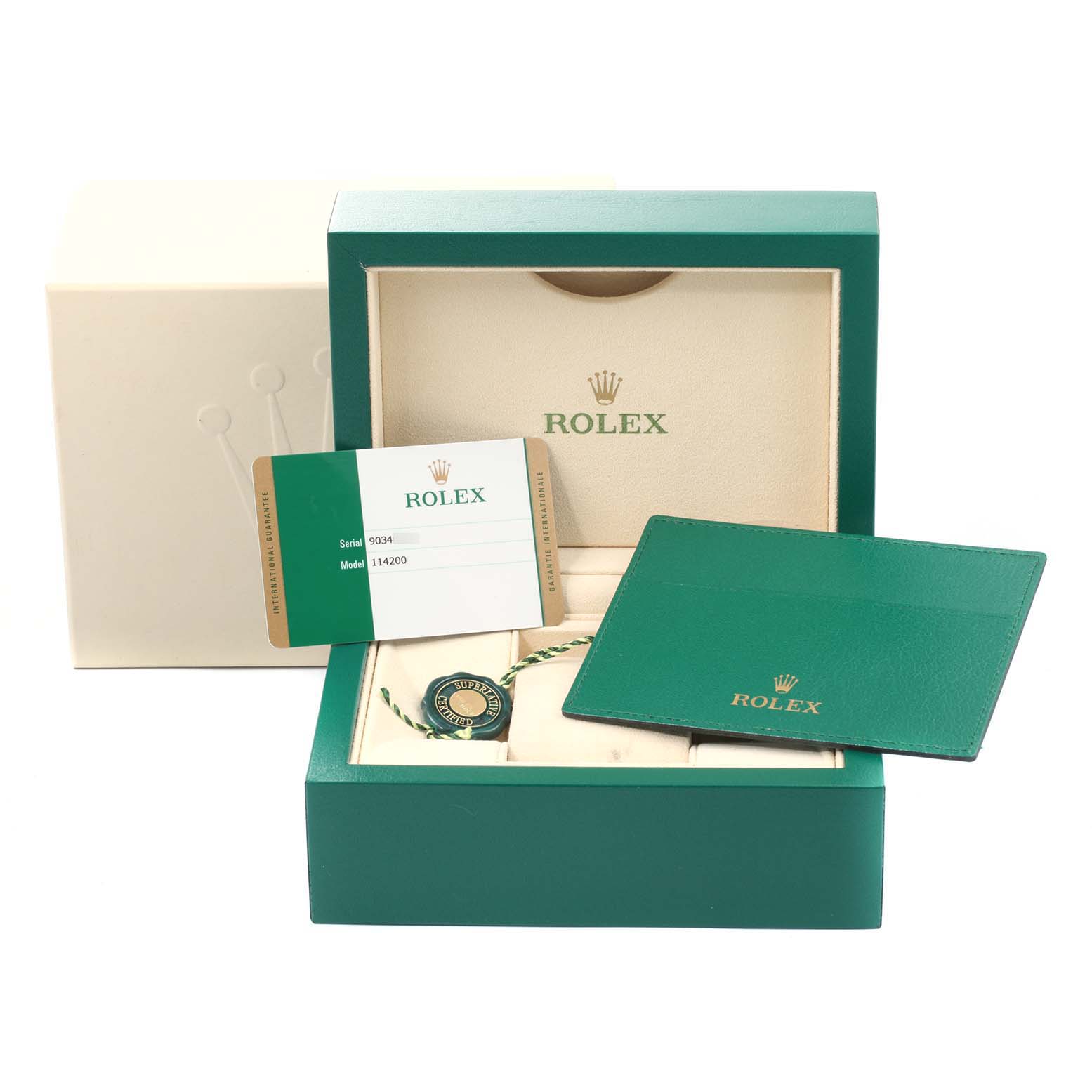 The image shows the packaging and accessories of a Rolex Oyster Perpetual 114200 Men's Stainless Steel Burgundy Dial 114200 Men's Stainless Steel Burgundy Dial watch, including the box, warranty card, and booklet.
