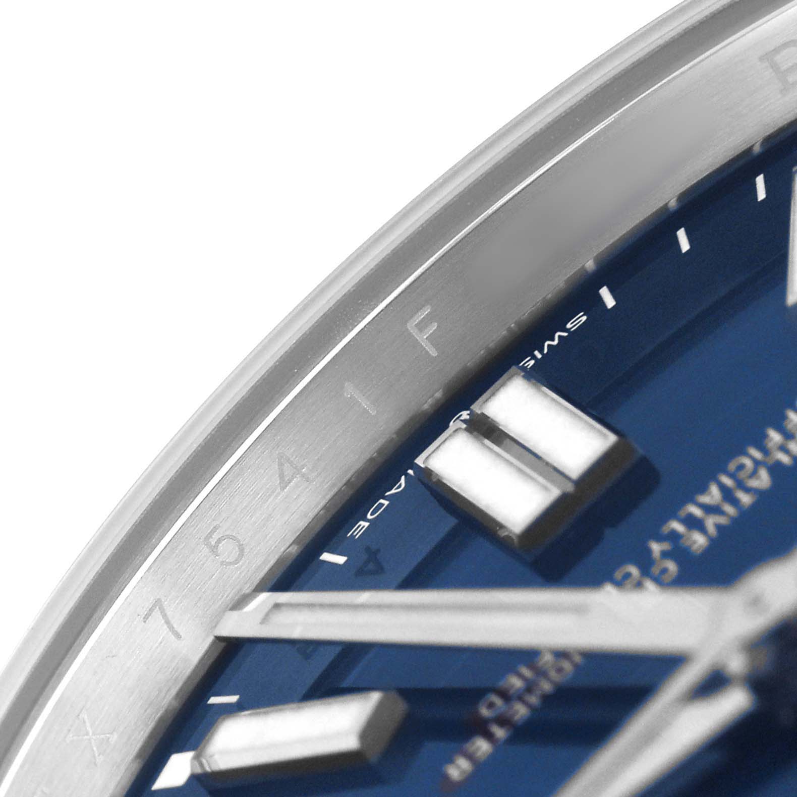 The image shows a close-up of the dial and bezel of a Rolex Oyster Perpetual 124300 Men's Stainless Steel Blue Dial watch, highlighting the hour markers and part of the bezel.
