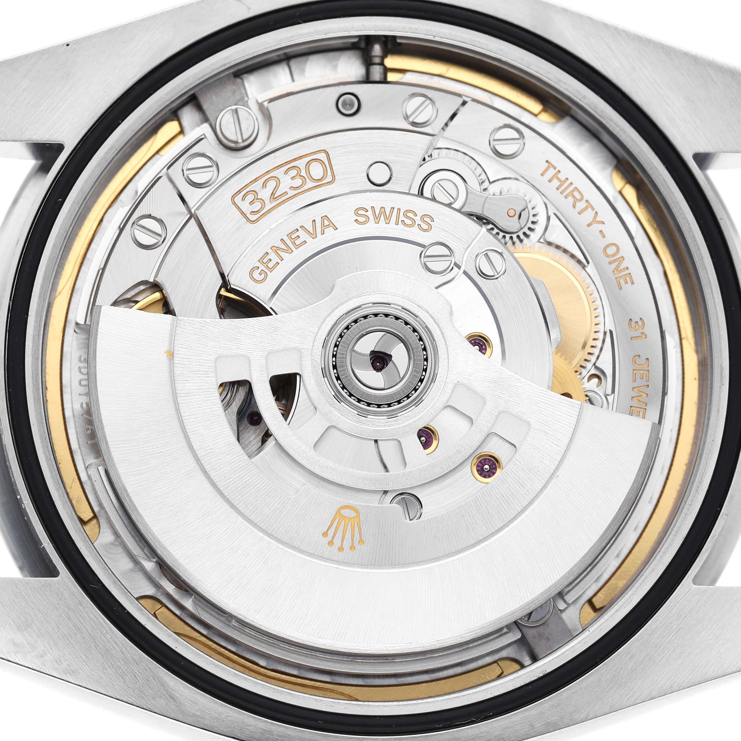 The image shows the movement of a Rolex Oyster Perpetual 124300 Men's Stainless Steel Blue Dial watch from the back, highlighting the intricate mechanism and components.
