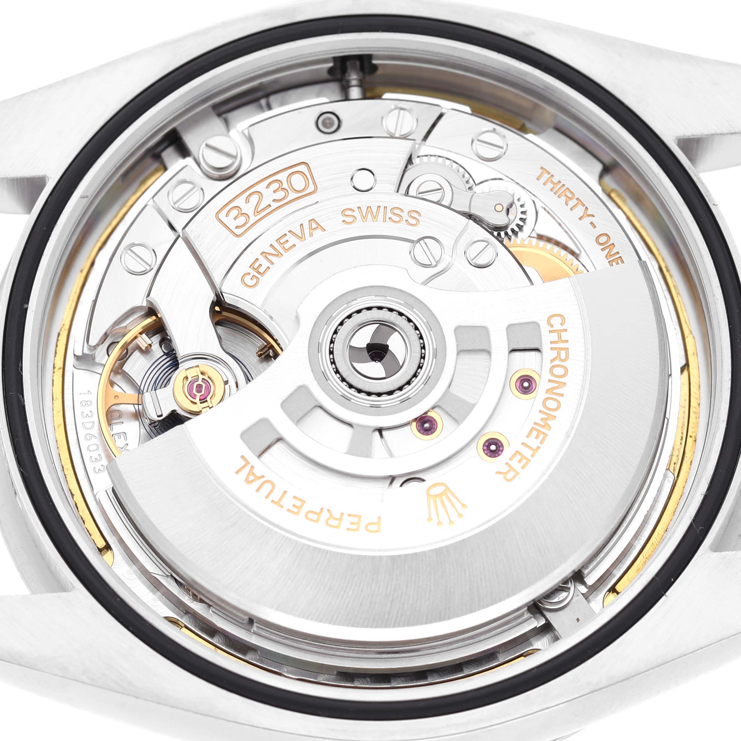 The image shows the movement of a Rolex Oyster Perpetual 134300 Men's Stainless Steel Blue Dial watch from a top-down view, highlighting the rotor and intricate mechanics.