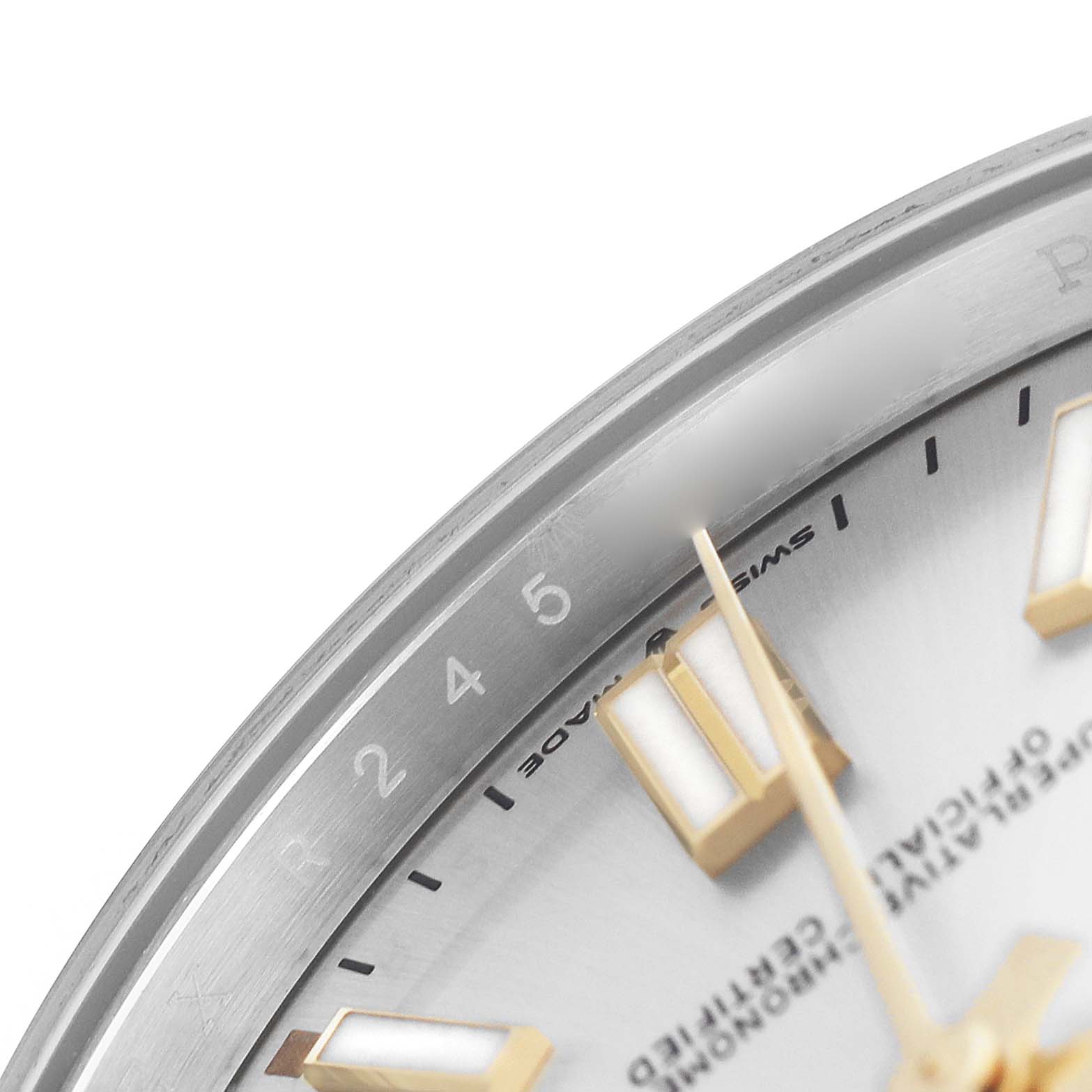 The image shows the edge of the dial and bezel of a Rolex Oyster Perpetual 124300 Men's Stainless Steel Silver Dial, showcasing part of the second markers and "Swiss Made" text.