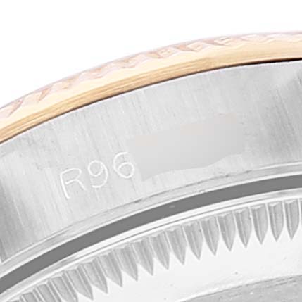 This image shows a close-up of the bezel and partially the case of the Rolex Oyster Perpetual 67193 Women
s Steel and Gold (two tone) Champagne Dial 67193 Women
s Steel and Gold (two tone) Champagne Dial watch.