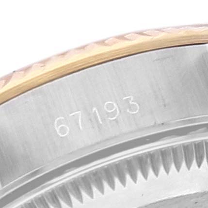 This image shows a close-up of the edge and the serial number (67193) of a Rolex Oyster Perpetual 67193 Women
s Steel and Gold (two tone) Champagne Dial 67193 Women
s Steel and Gold (two tone) Champagne Dial watch.