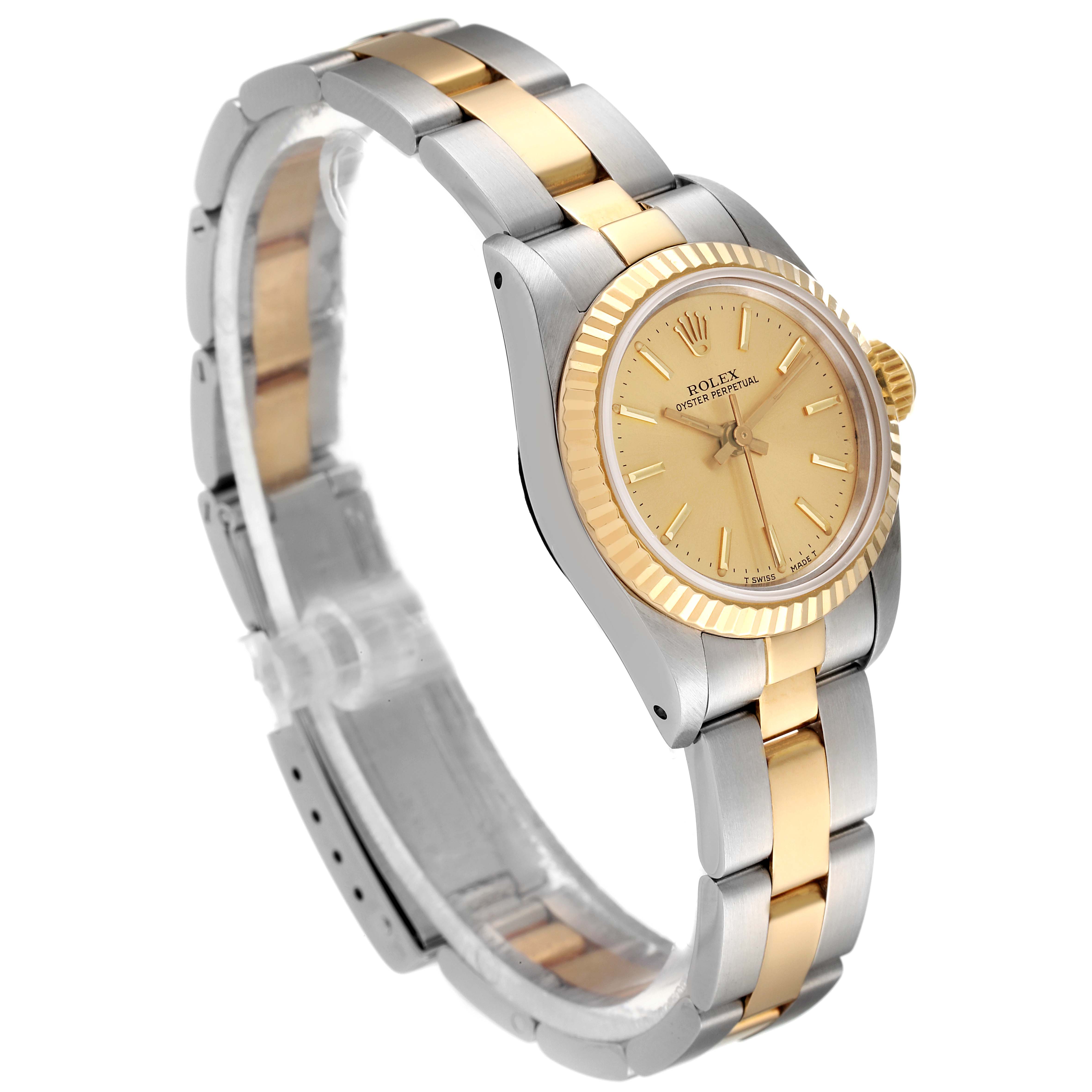 The Rolex Oyster Perpetual 67193 Women
s Steel and Gold (two tone) Champagne Dial 67193 Women
s Steel and Gold (two tone) Champagne Dial watch is shown at a three-quarter angle, displaying its face, fluted bezel, and two-tone bracelet.