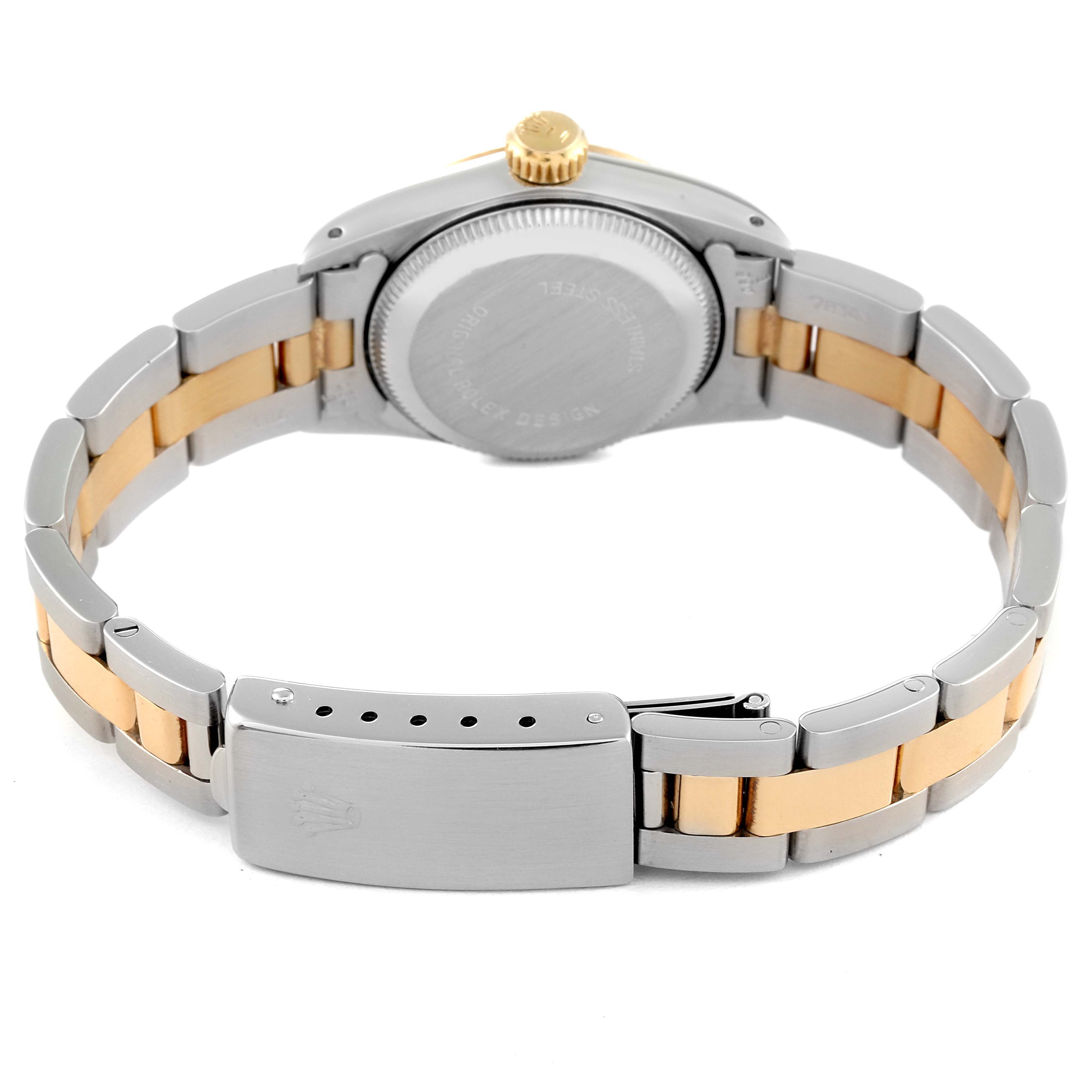 This Rolex Oyster Perpetual 67193 Women
s Steel and Gold (two tone) Champagne Dial 67193 Women
s Steel and Gold (two tone) Champagne Dial watch is shown from the back, highlighting the case back, bracelet, and clasp.