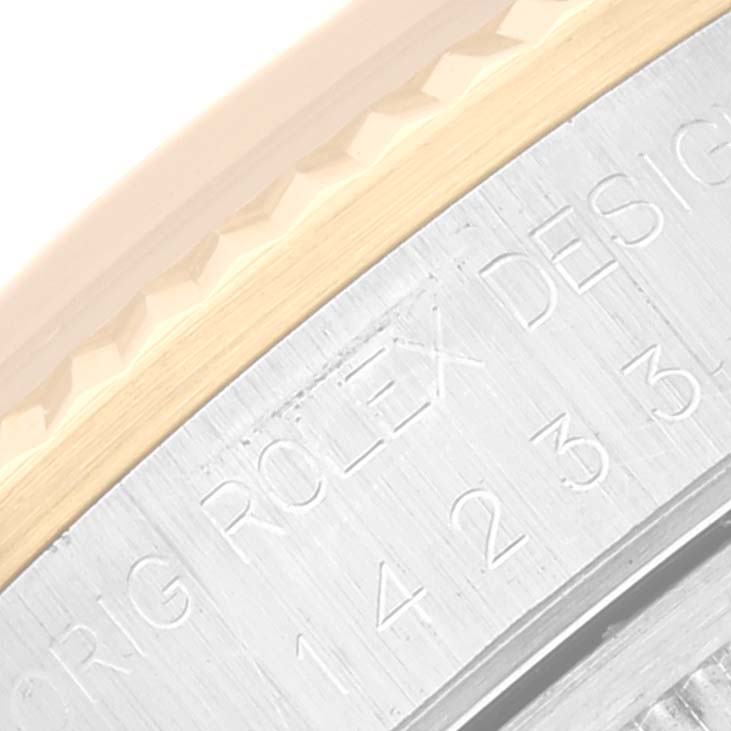 This image shows a close-up angle of the etched text and part of the bezel on a Rolex Oyster Perpetual 14233 Men's Steel and Gold (two tone) Champagne Dial 14233 Men's Steel and Gold (two tone) Champagne Dial watch.