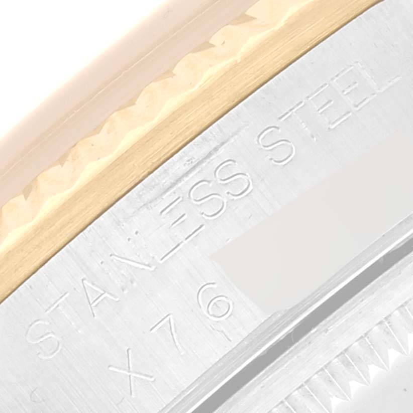 This image is a close-up of the side of a Rolex Oyster Perpetual 14233 Men's Steel and Gold (two tone) Champagne Dial 14233 Men's Steel and Gold (two tone) Champagne Dial watch showing the stainless steel engraving.