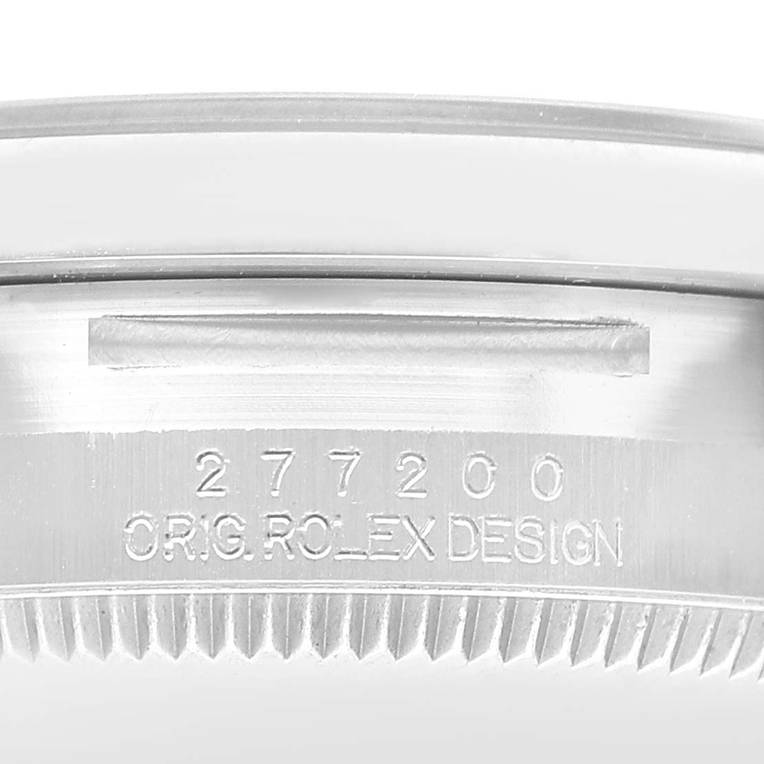 The image shows a close-up of the side of a Rolex Oyster Perpetual 277200 Women's Stainless Steel Green Dial watch case with engraving and grooved edges.