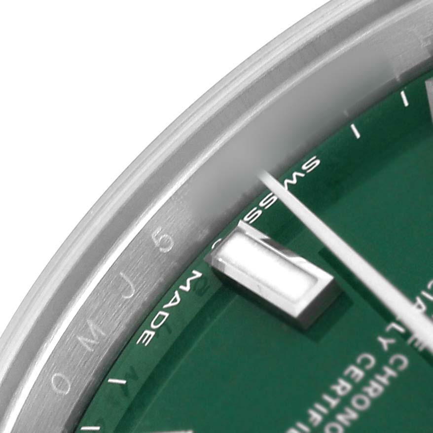 The image shows a close-up of the Rolex Oyster Perpetual 277200 Women's Stainless Steel Green Dial watch's green dial, silver hand, and hour marker from the side angle.