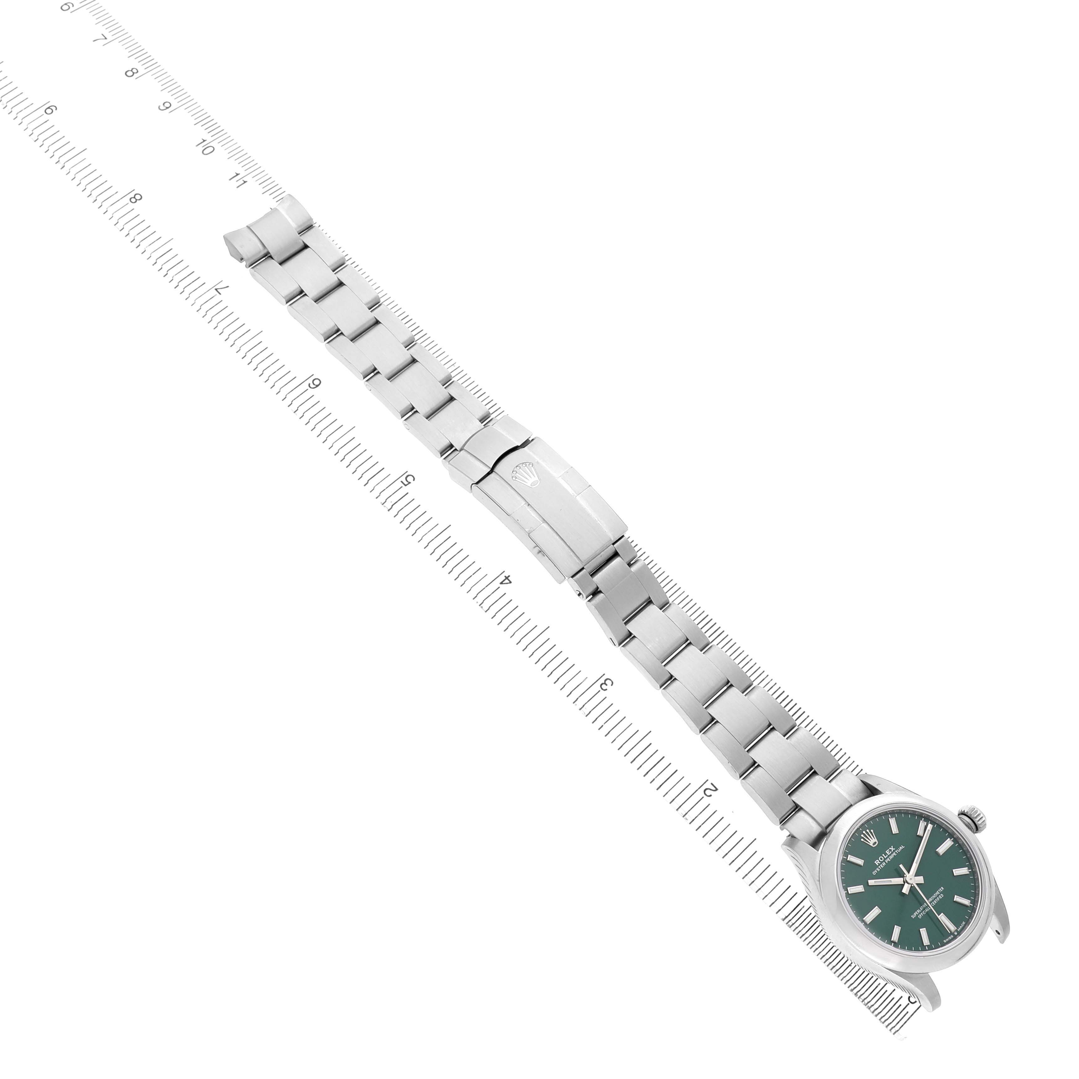 The Rolex Oyster Perpetual 277200 Women's Stainless Steel Green Dial watch is shown diagonally, displaying the face, bezel, and bracelet.