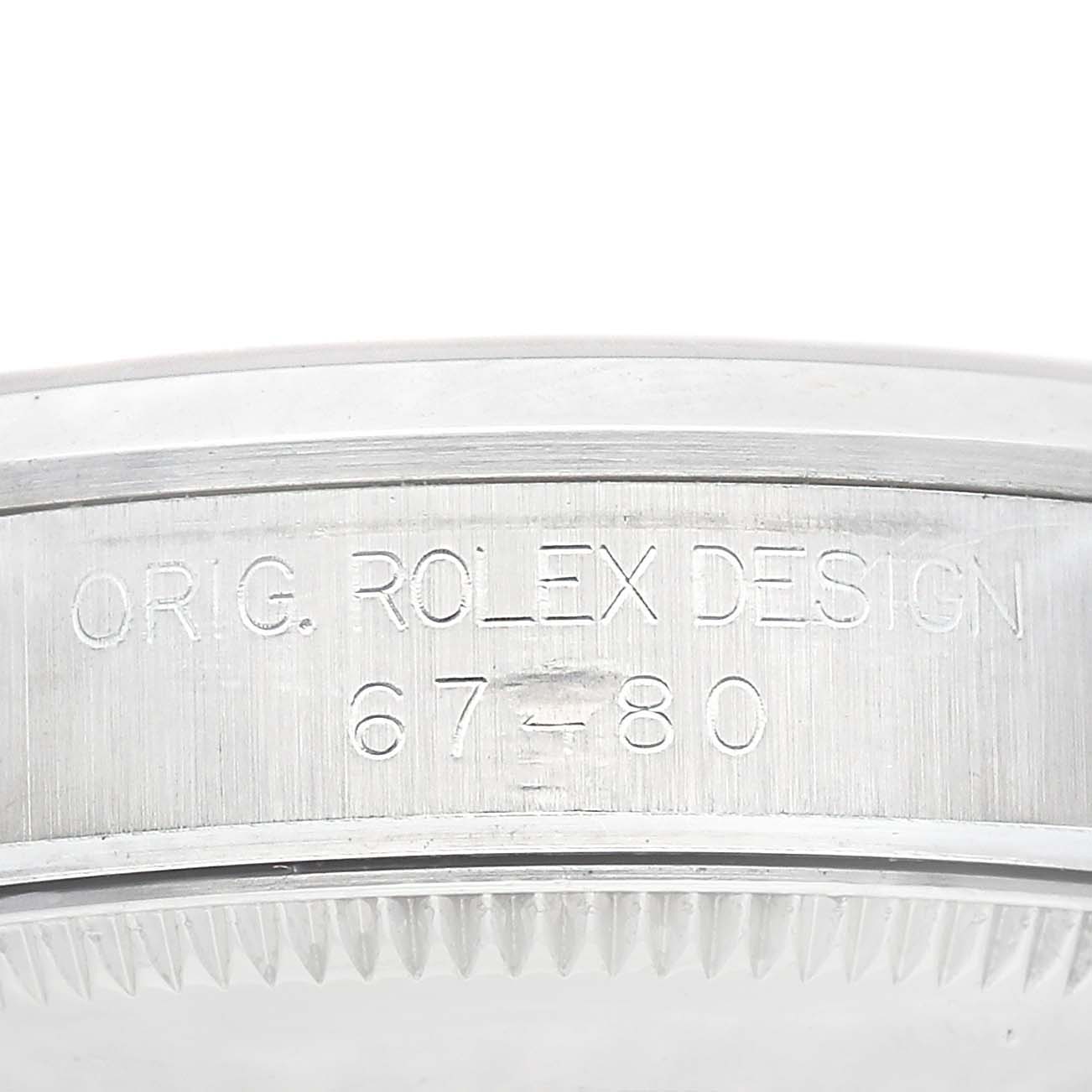 The image shows a close-up of the side engraving on a Rolex Mid-Size 67480 Women's Stainless Steel Pink Dial watch, featuring the model and design details.