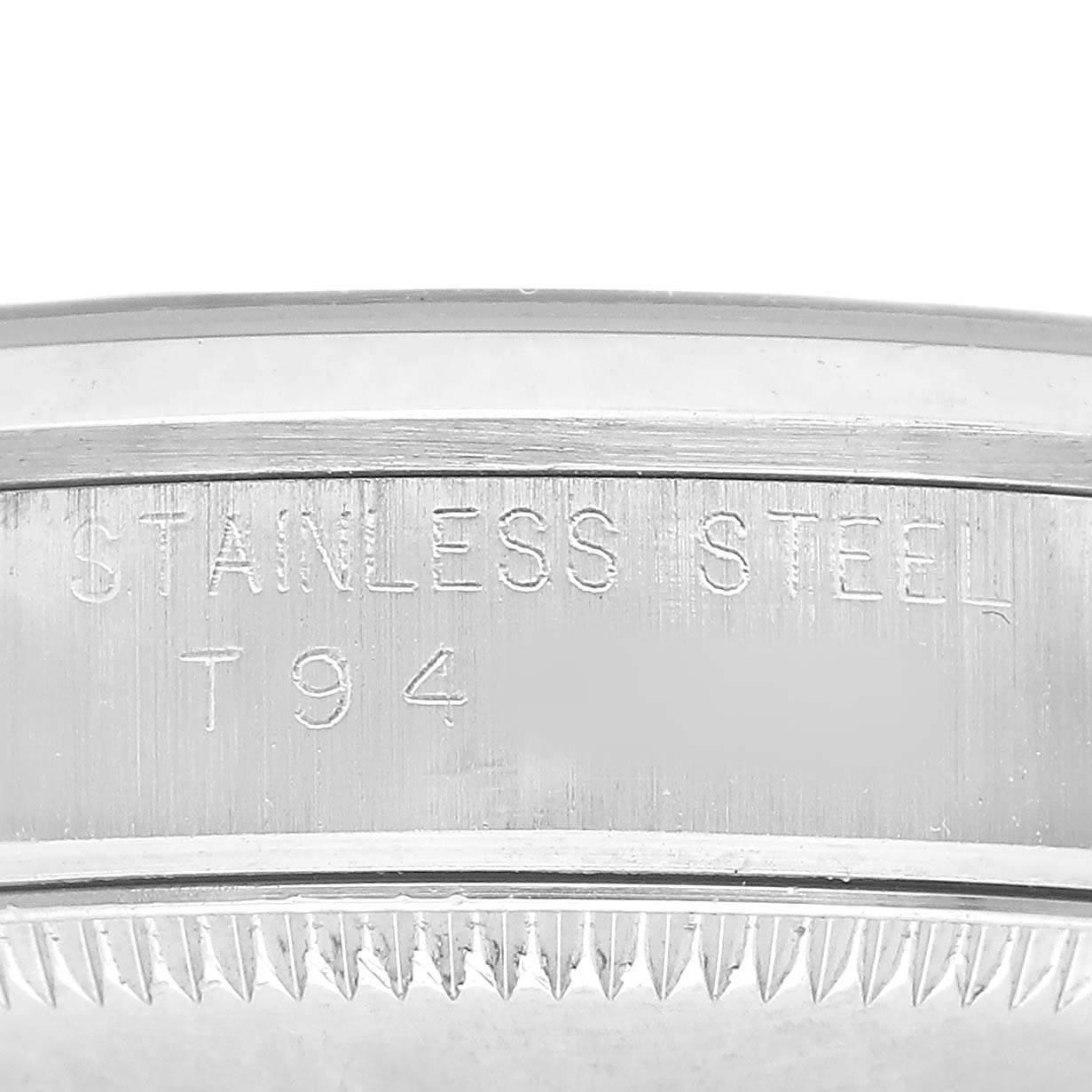 The image shows a close-up of the side of a stainless steel Rolex Mid-Size 67480 Women's Stainless Steel Pink Dial model, highlighting its engraved details.