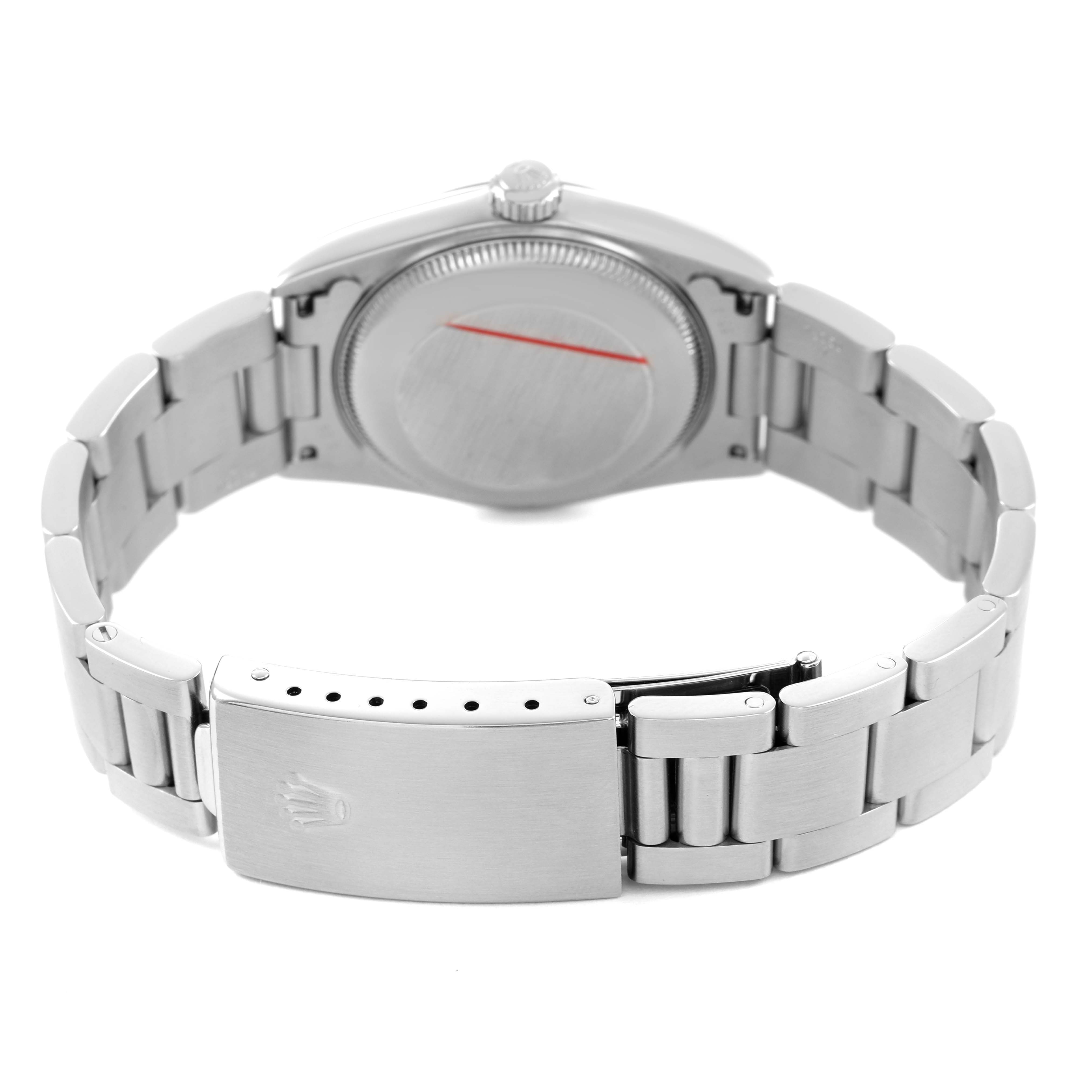 The image shows the back view of a Rolex Oyster Perpetual 77080 Women's Stainless Steel Silver Dial, highlighting its closed case back and metal bracelet with a clasp.