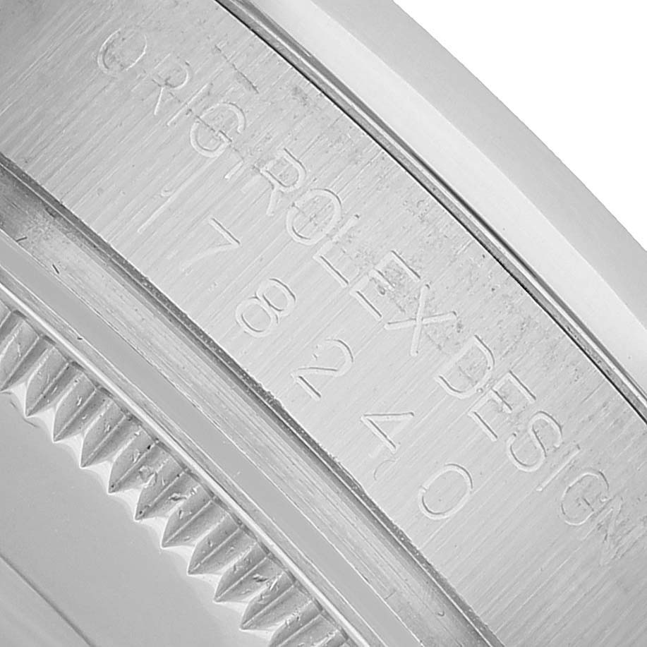 The image shows a close-up of the inner bezel with engravings of a Rolex Oyster Perpetual 77080 Women's Stainless Steel Silver Dial watch.
