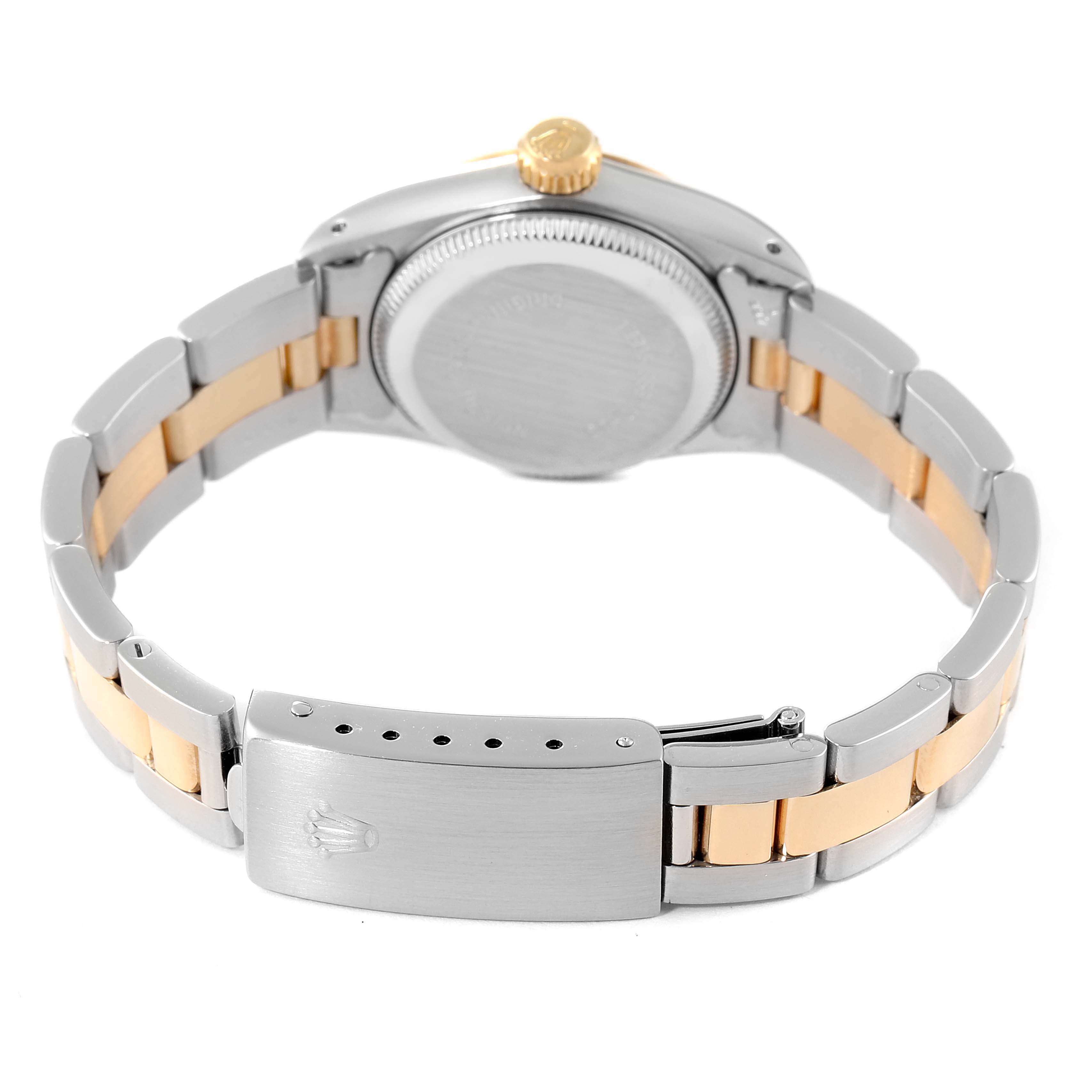 The image shows the back of a Rolex Oyster Perpetual 67233 Women
s Steel and Gold (two tone) Champagne Dial 67233 Women
s Steel and Gold (two tone) Champagne Dial watch, highlighting its two-tone bracelet and closed clasp.