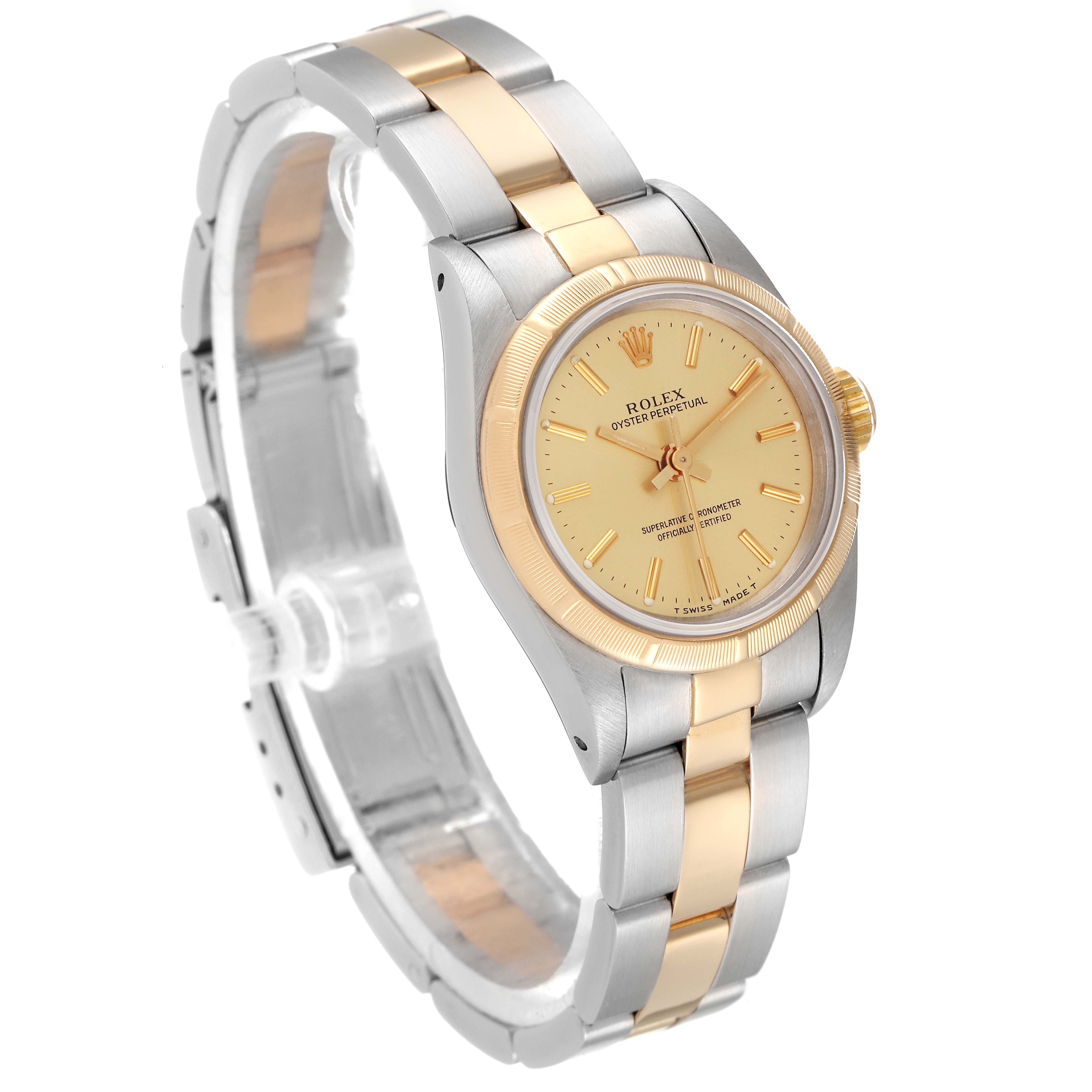 This Rolex Oyster Perpetual 67233 Women
s Steel and Gold (two tone) Champagne Dial 67233 Women
s Steel and Gold (two tone) Champagne Dial watch is shown at a three-quarter angle, highlighting its two-tone bracelet and champagne-colored dial.