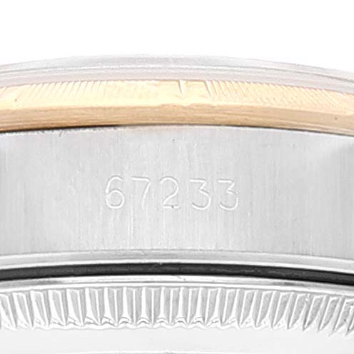 This image shows a close-up of the Rolex Oyster Perpetual 67233 Women
s Steel and Gold (two tone) Champagne Dial 67233 Women
s Steel and Gold (two tone) Champagne Dial watch
s case side, featuring the reference number 67233.