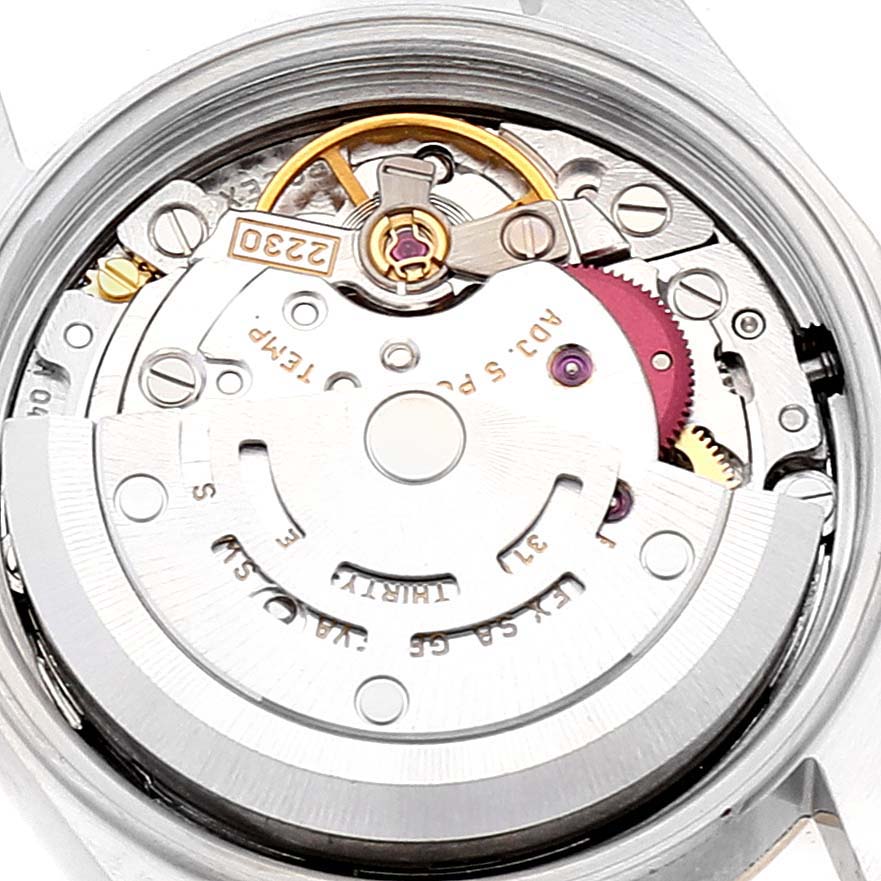 This image shows the internal mechanism of the Rolex Oyster Perpetual 76183 Women's Steel and Gold (two tone) Grey Dial 76183 Women's Steel and Gold (two tone) Grey Dial watch, featuring gears and the rotor.