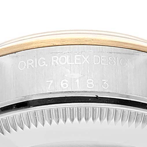 This image shows a close-up of the side of the case of a Rolex Oyster Perpetual 76183 Women's Steel and Gold (two tone) Grey Dial 76183 Women's Steel and Gold (two tone) Grey Dial, highlighting the serial number engraving and bezel.