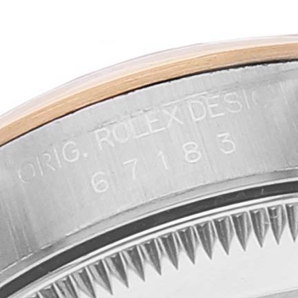 The image shows a close-up of the side of the Rolex Oyster Perpetual 67183 Women
s Steel and Gold (two tone) Blue Dial 67183 Women
s Steel and Gold (two tone) Blue Dial watch, highlighting part of the case and bezel with the model number.