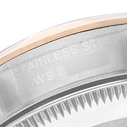 This image shows a close-up of the bezel and part of the casing of a Rolex Oyster Perpetual 67183 Women
s Steel and Gold (two tone) Blue Dial 67183 Women
s Steel and Gold (two tone) Blue Dial watch, highlighting the stainless steel material.