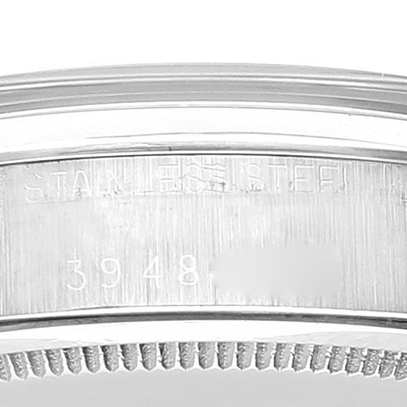 This image shows a close-up of the side of a Rolex Date 6694 Men's Stainless Steel Black Dial 6694 Men's Stainless Steel Black Dial model watch, with focus on the bezel and serial number area engraved on the case.