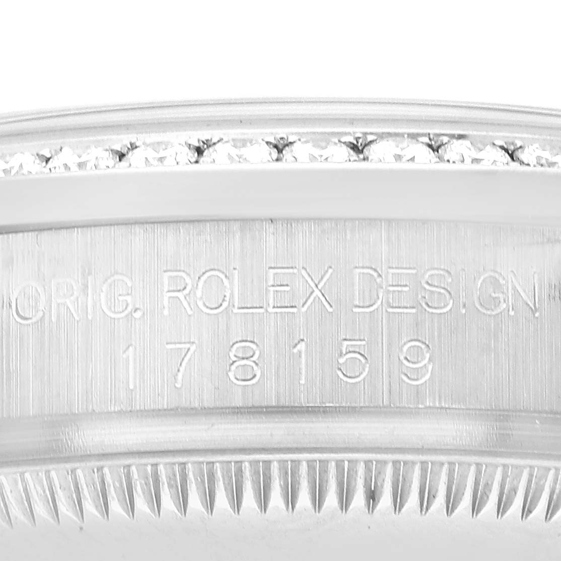 The image shows a close-up of the Rolex President 178159 Women's White Gold Silver Dial model's case side, highlighting the engraved model number and the diamond-set bezel.