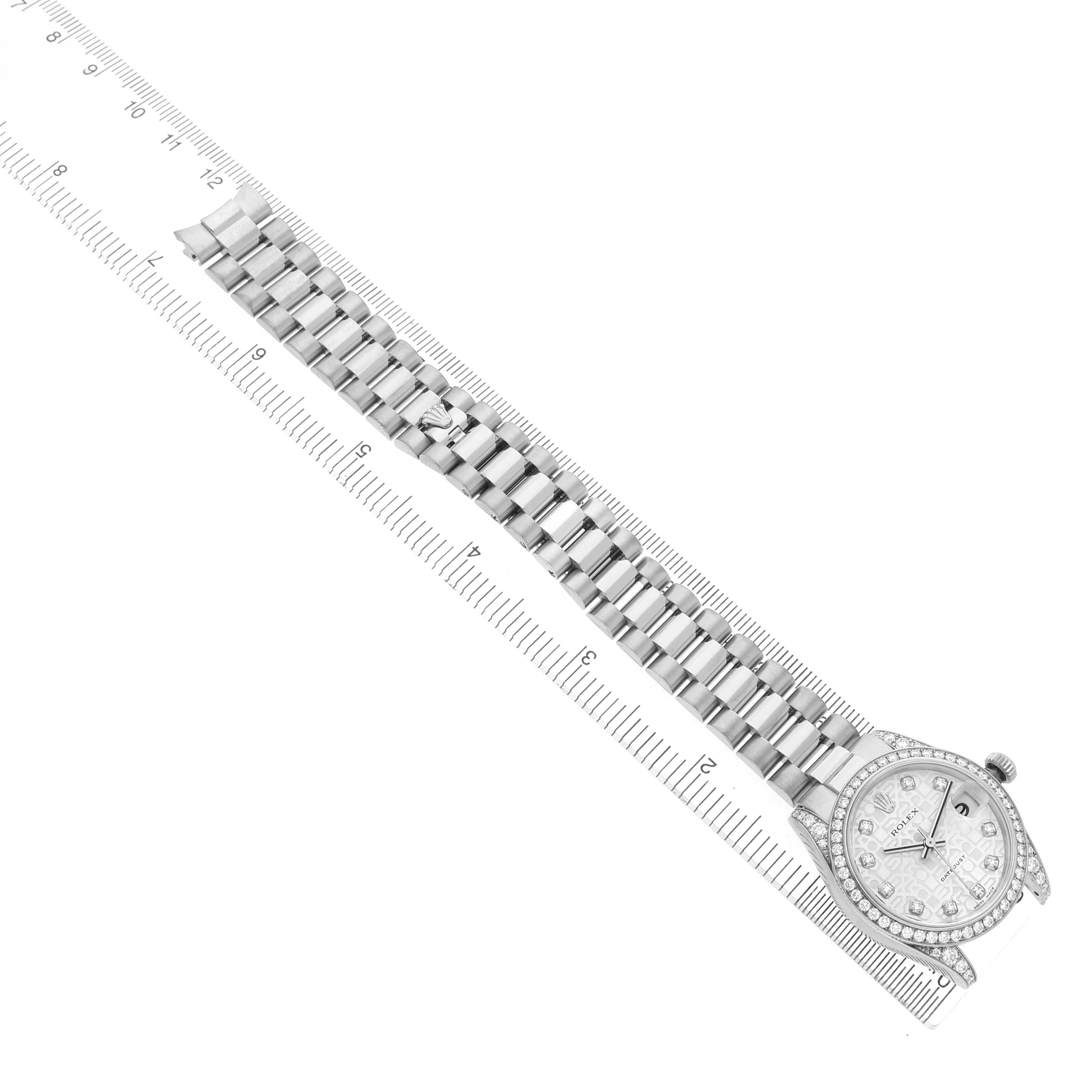 The image shows a Rolex President 178159 Women's White Gold Silver Dial model watch laid flat with the face and band visible alongside a ruler for scale.