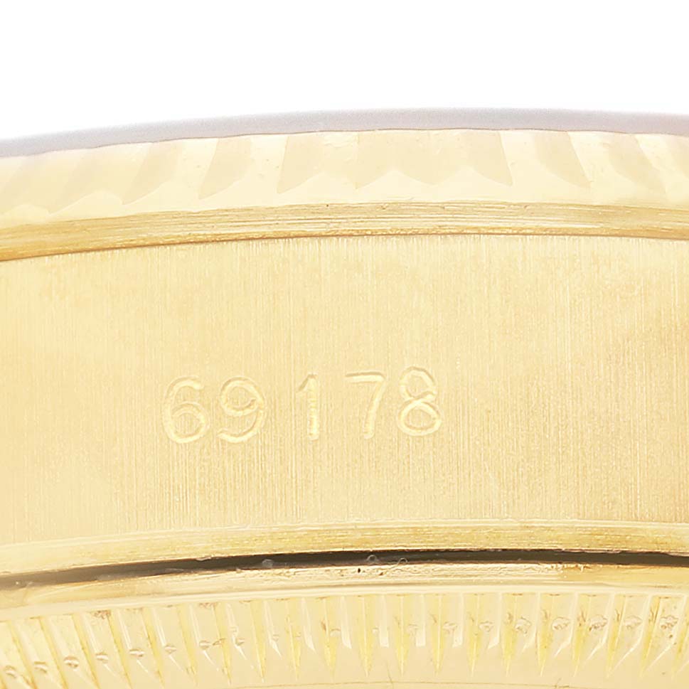 The image shows a close-up of the side edge and serial number engraving on a Rolex Datejust 69178 Women's Yellow Gold Champagne Dial watch.