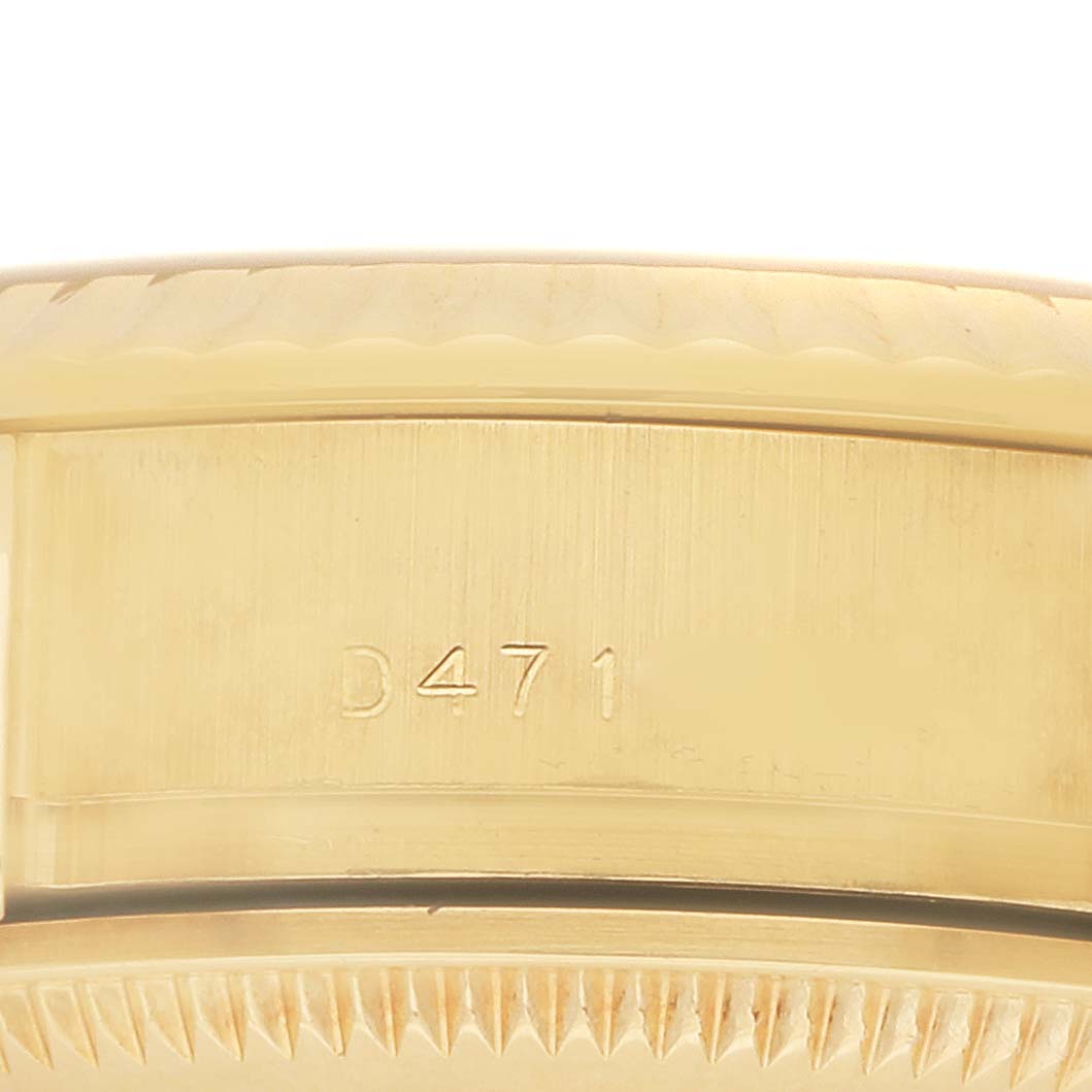 The image shows a close-up of the side of the Rolex President 179178 Women
s Yellow Gold Champagne Dial 179178 Women
s Yellow Gold Champagne Dial watch, focusing on the case with some engraved numbers.