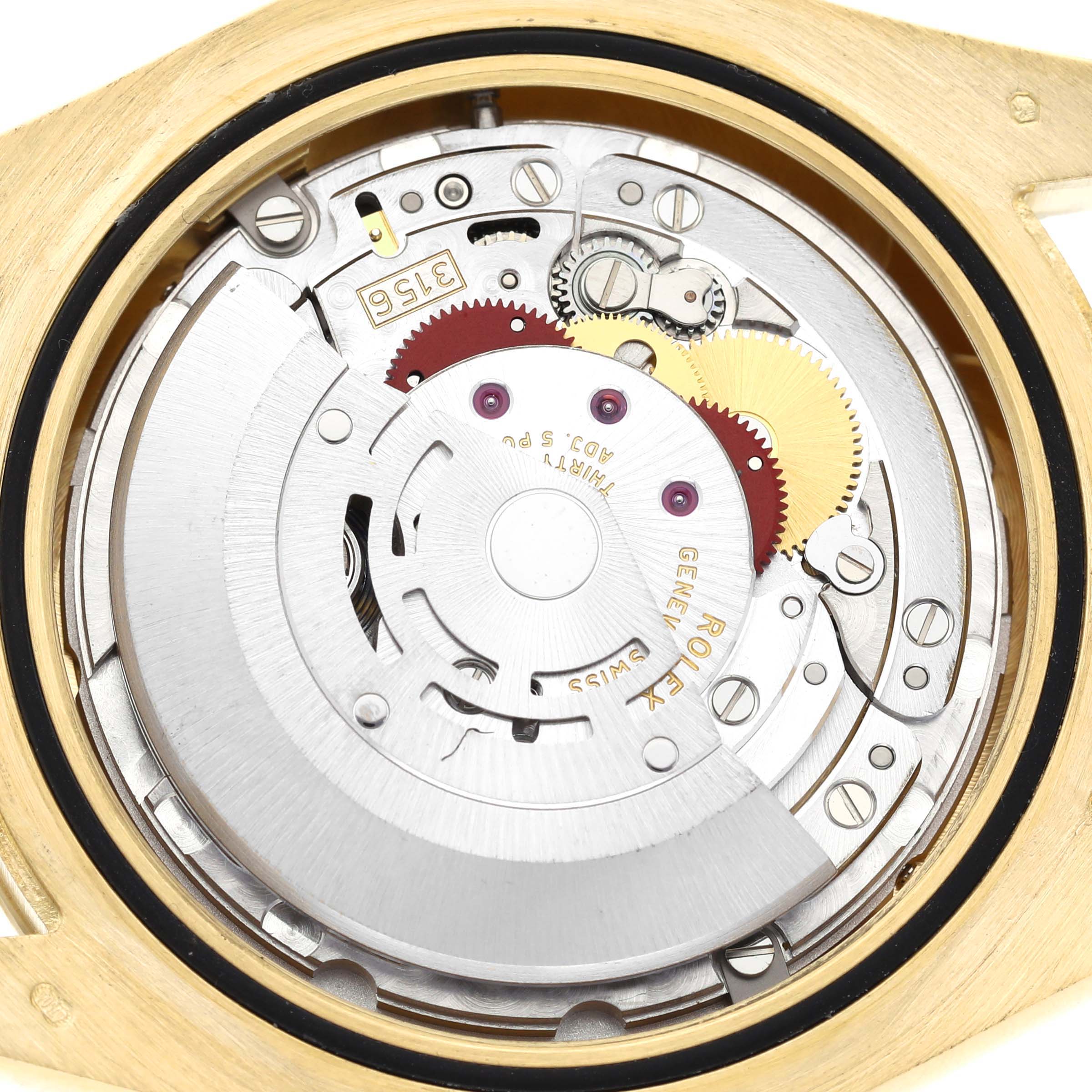 The image shows the movement and rotor of a Rolex President 218348 Men's Yellow Gold Champagne Dial watch from a rear angle, highlighting its intricate mechanical parts.