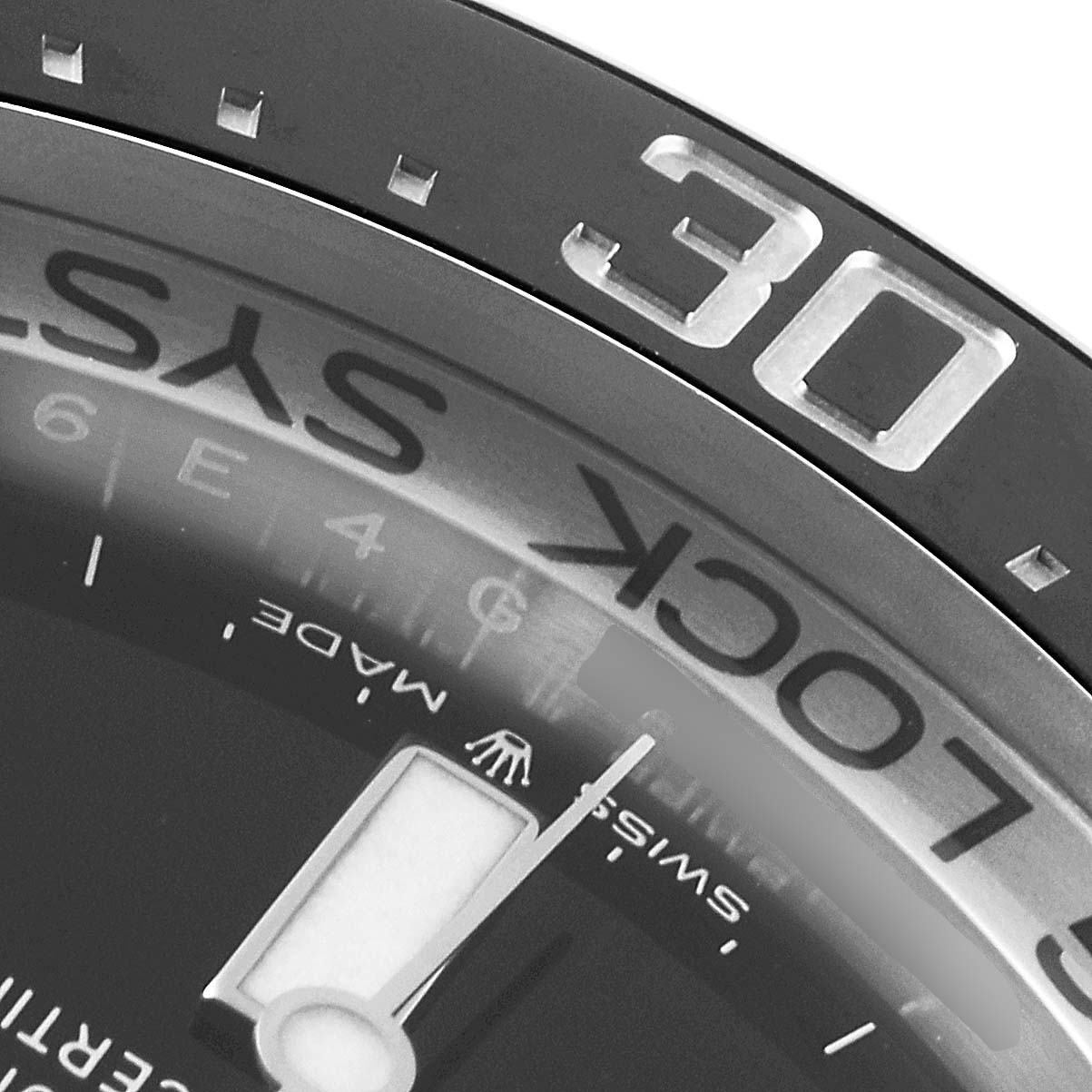 This close-up of a Rolex Sea-Dweller 2019 Men
s Stainless Steel Blue Dial 2019 Men
s Stainless Steel Blue Dial watch displays the bezel, part of the dial, and the minute hand.