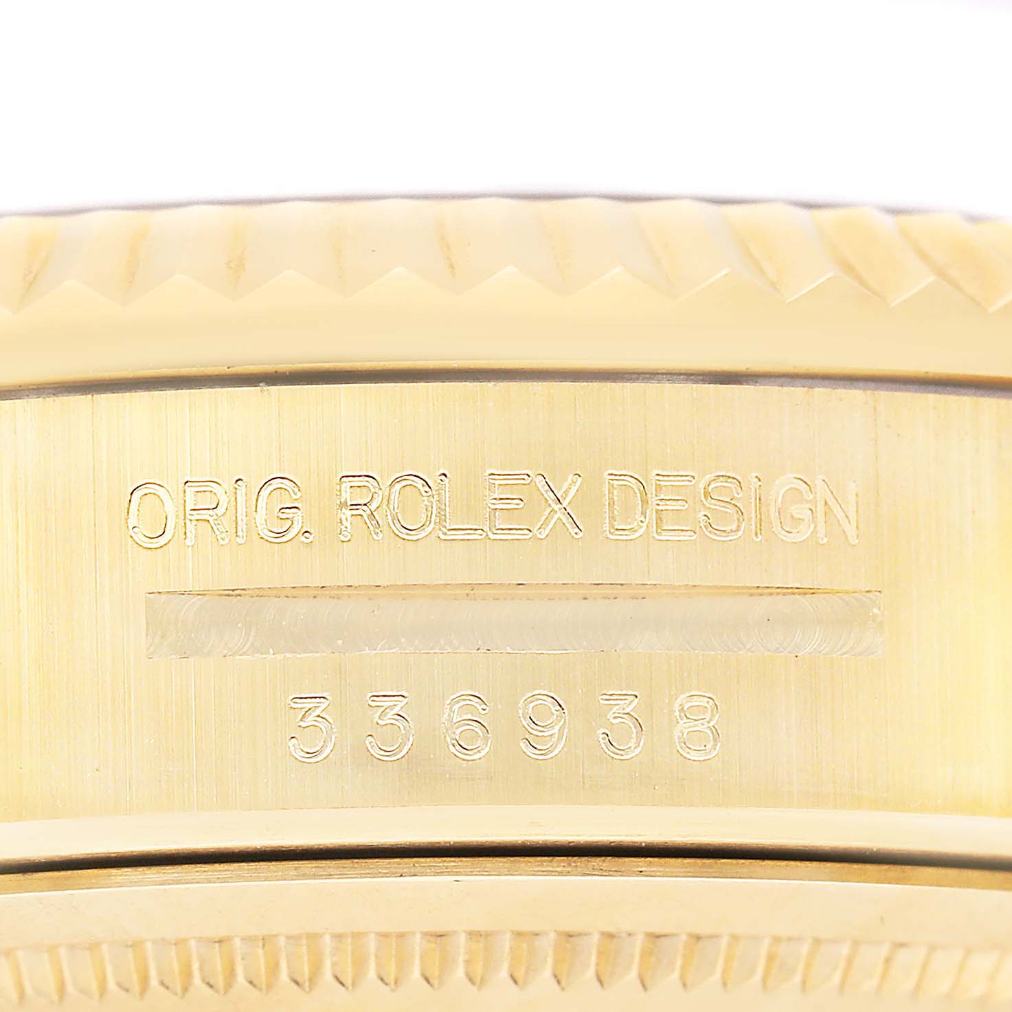 The image shows the side engraving on the case of a Rolex Sky-Dweller 336938 Men's Yellow Gold Black Dial, highlighting the design and model number.