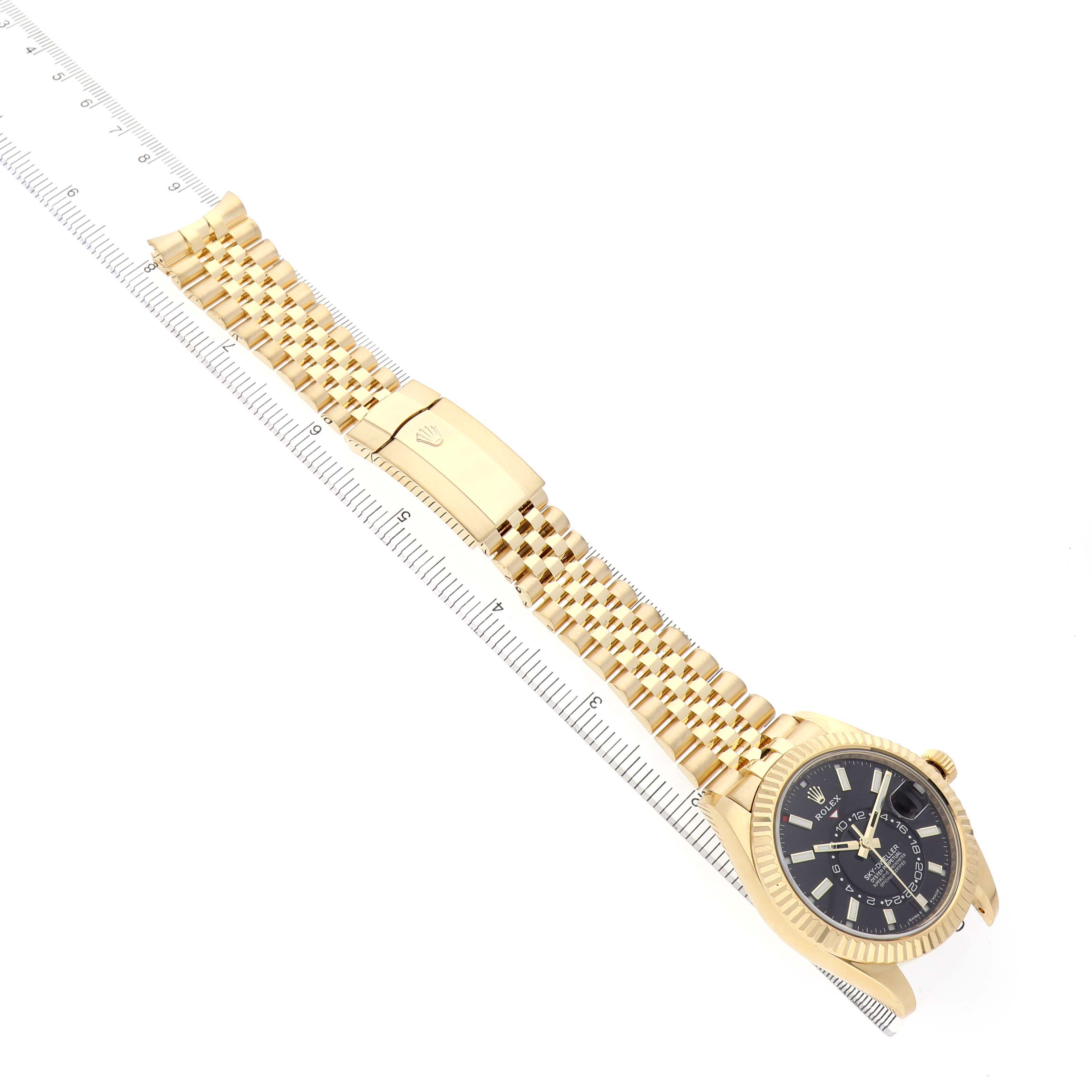 The Rolex Sky-Dweller 336938 Men's Yellow Gold Black Dial watch is shown at an angle highlighting the gold bracelet, clasp, and black dial.