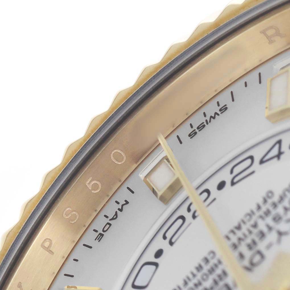 The image shows a close-up of the bezel and part of the dial of a Rolex Sky-Dweller 326238 Men's Yellow Gold White Dial watch.