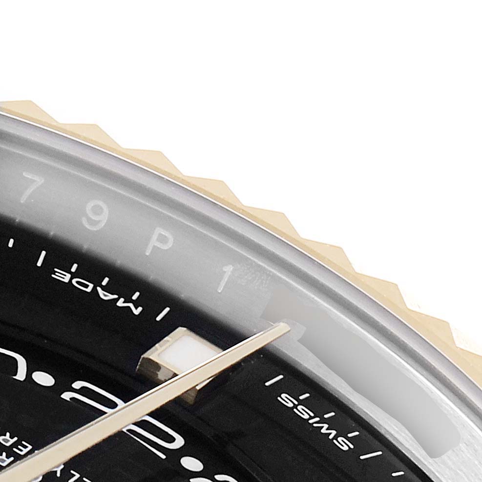 The image shows a close-up of the bezel and part of the dial of a Rolex Sky-Dweller 326933 Men's Steel and Gold (two tone) Black Dial 326933 Men's Steel and Gold (two tone) Black Dial watch.