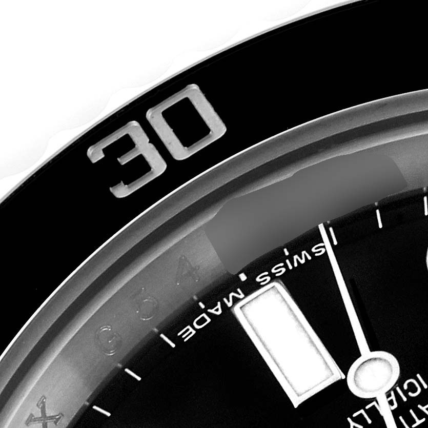 This image shows a close-up of the bezel and dial of a Rolex Submariner 116610 Men
s Stainless Steel Black Dial 116610 Men
s Stainless Steel Black Dial watch, focusing on the 30-minute mark and part of the "Swiss Made" text.